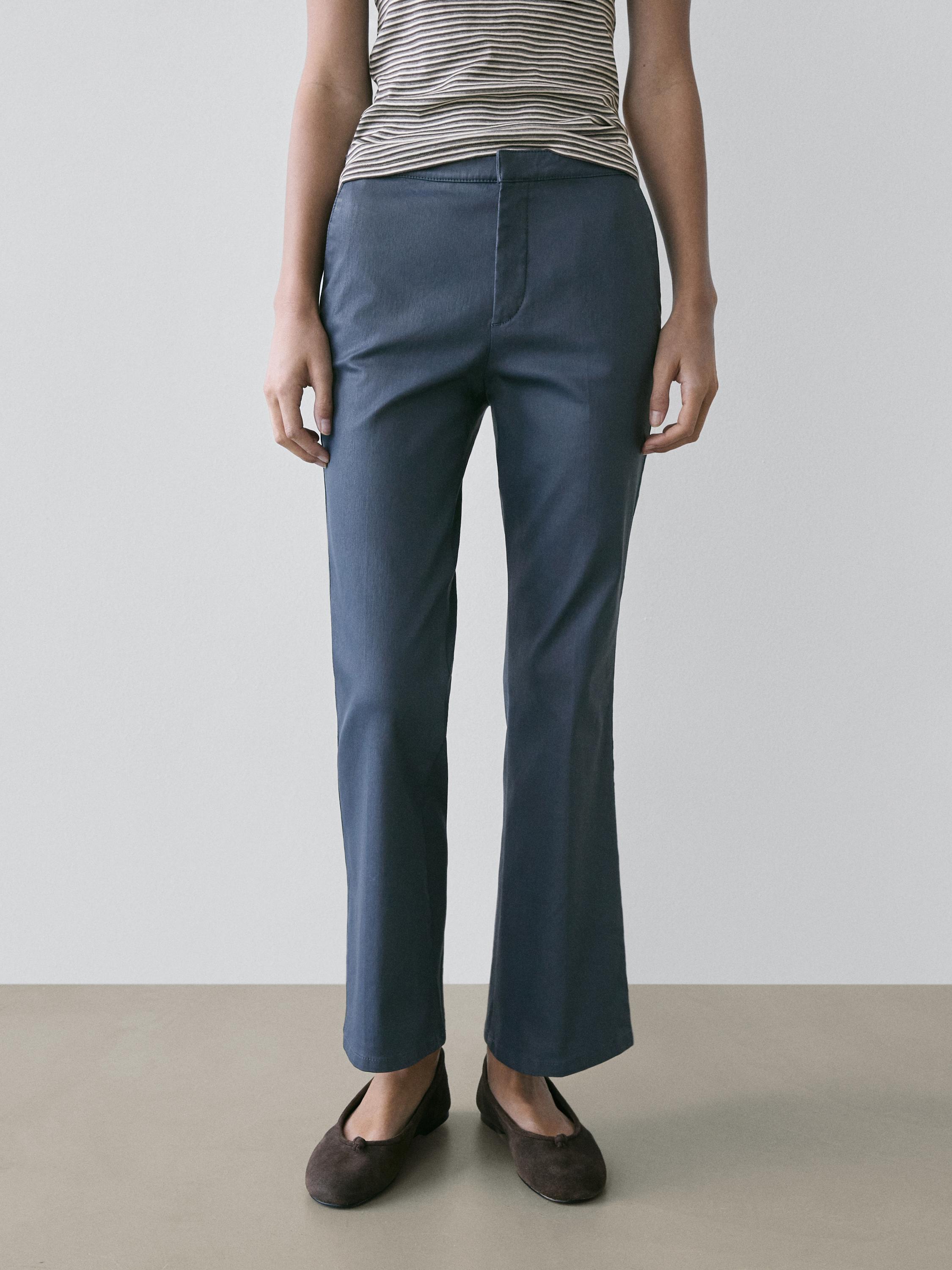Blue cropped flare fit pants set with front closure, no visible pockets.
