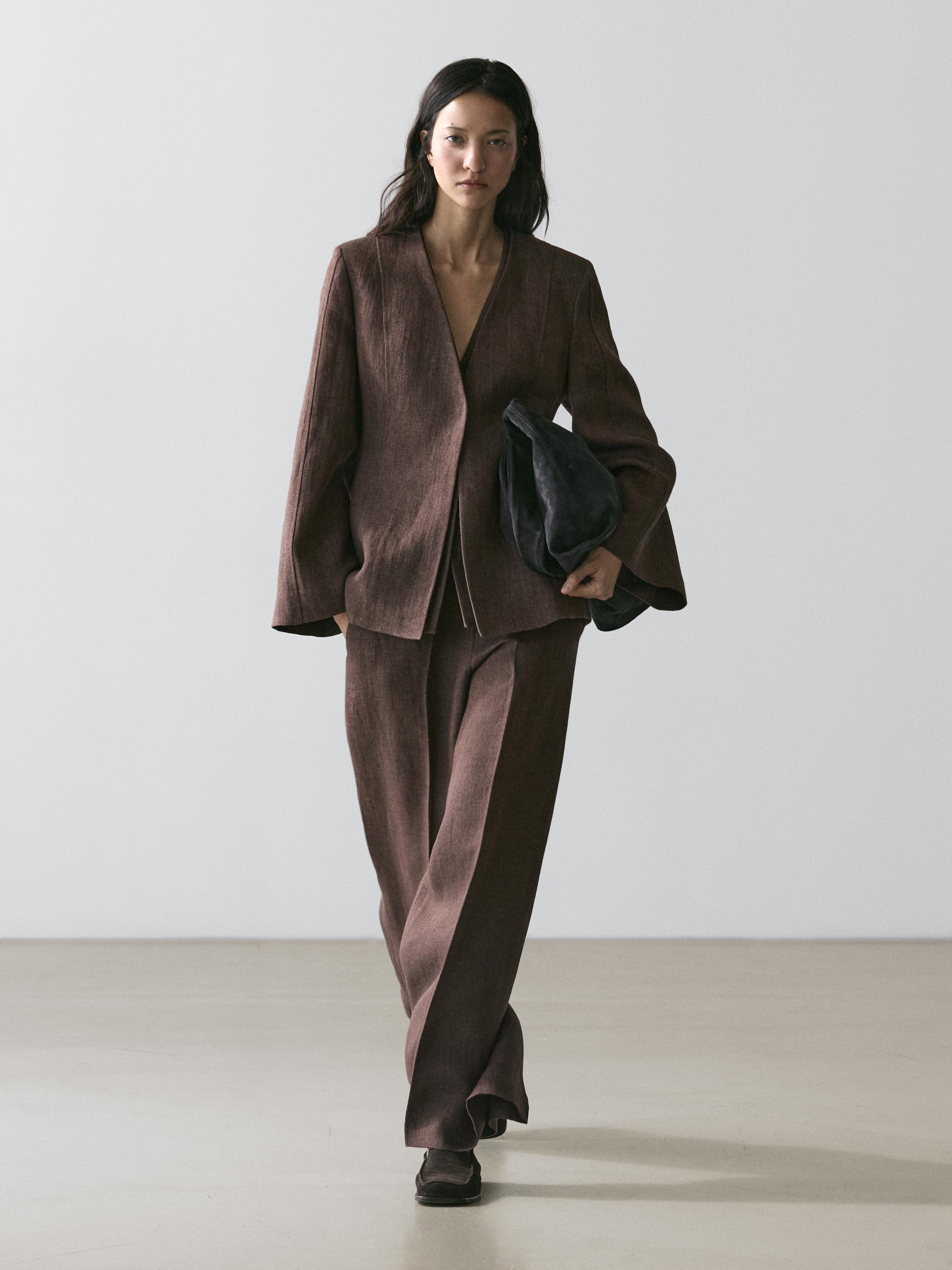 Brown lapel-less blazer and matching pants set, both straight-cut and loose-fitting.