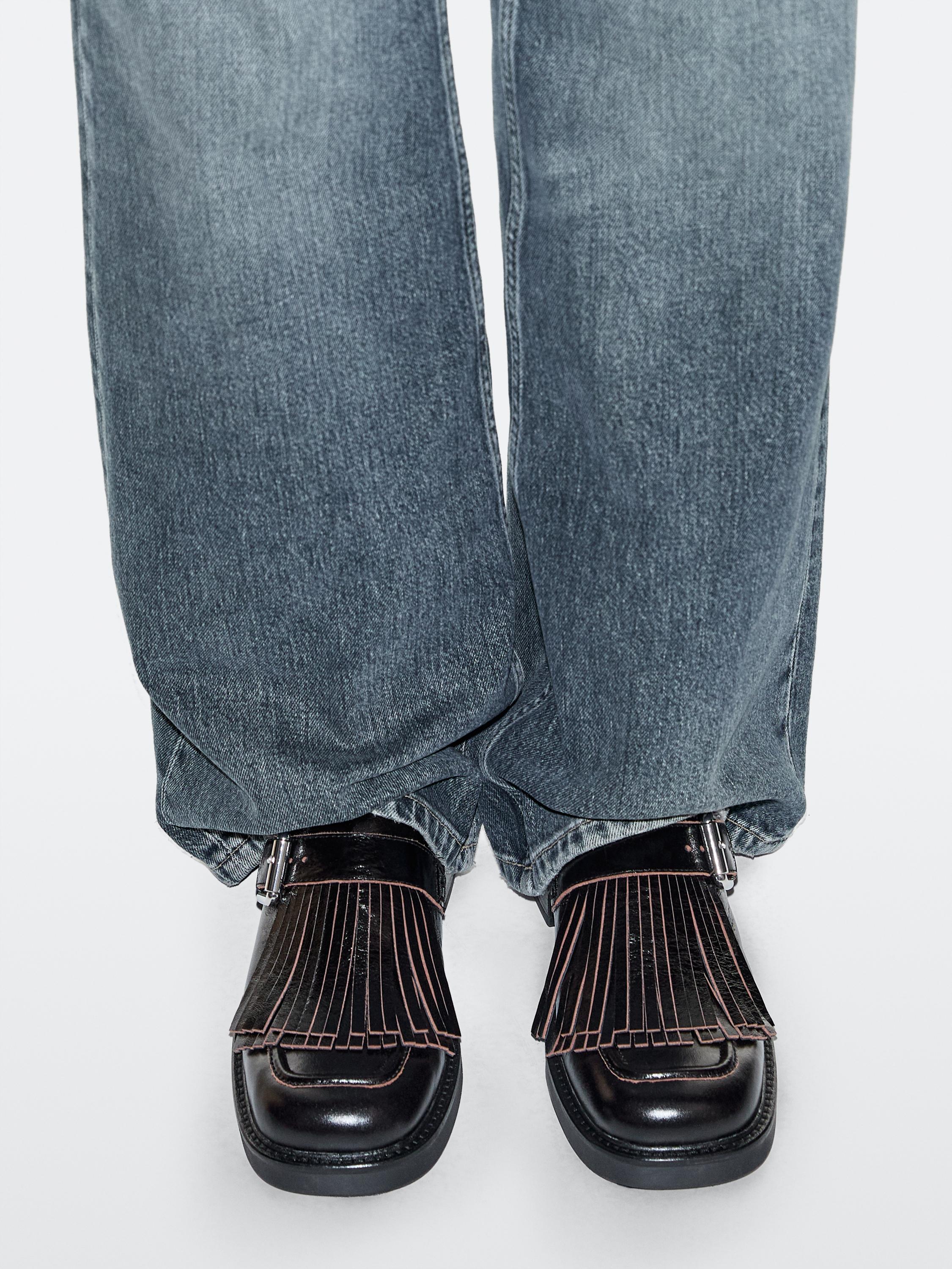 Buckled derby shoes with fringe — BLACK