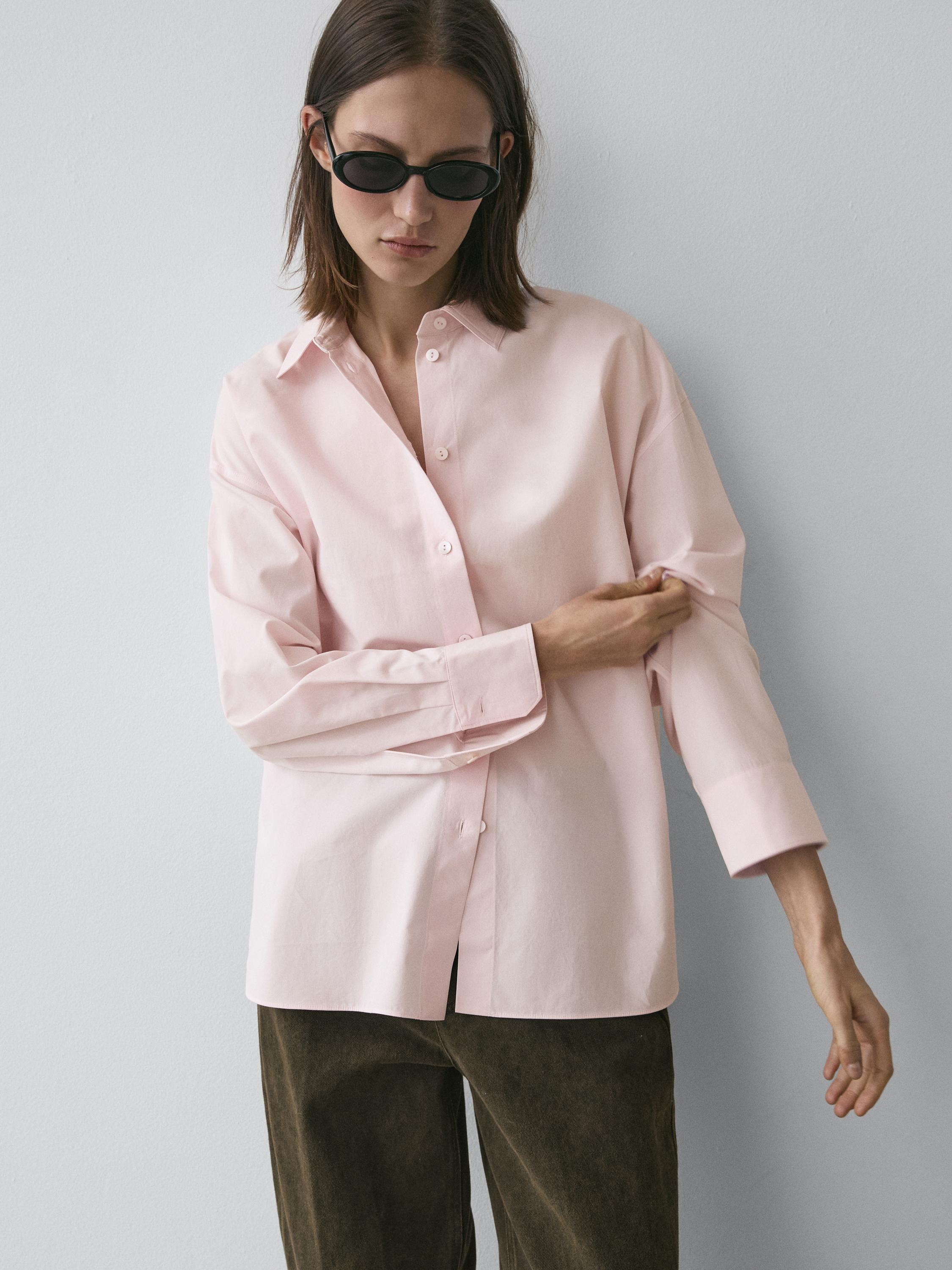 Pink button-up shirt and brown pants set.