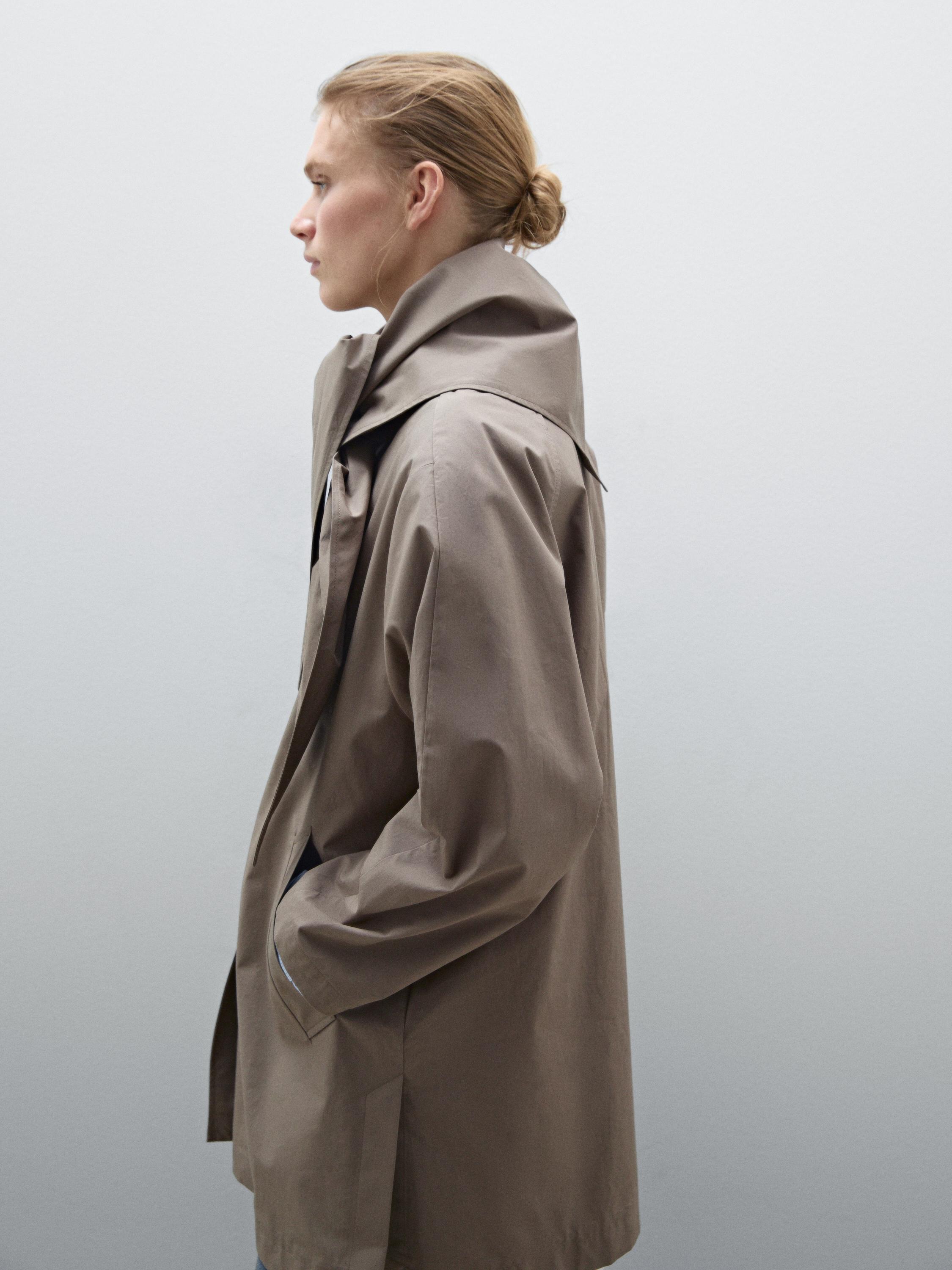 Trench coat with detachable scarf detail