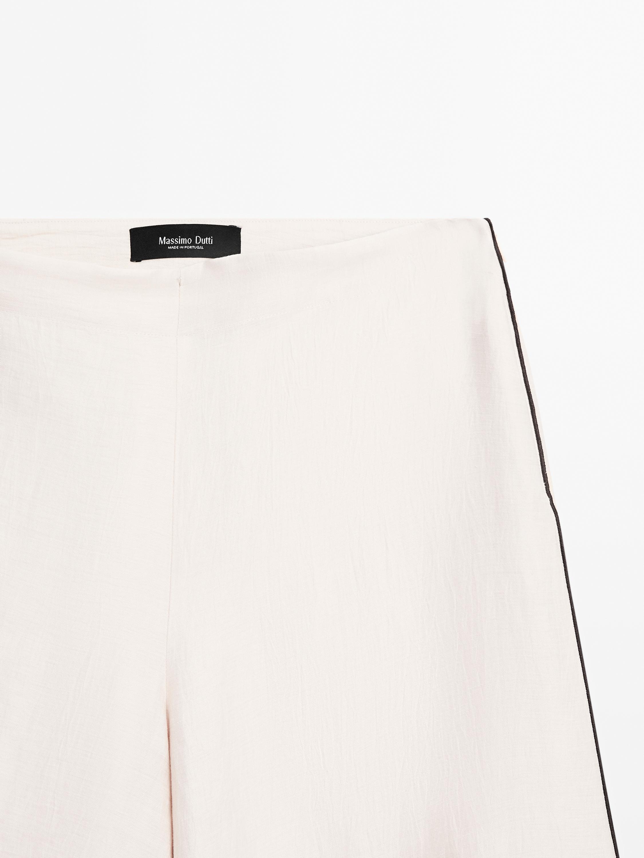 Flowing trousers with contrast trims