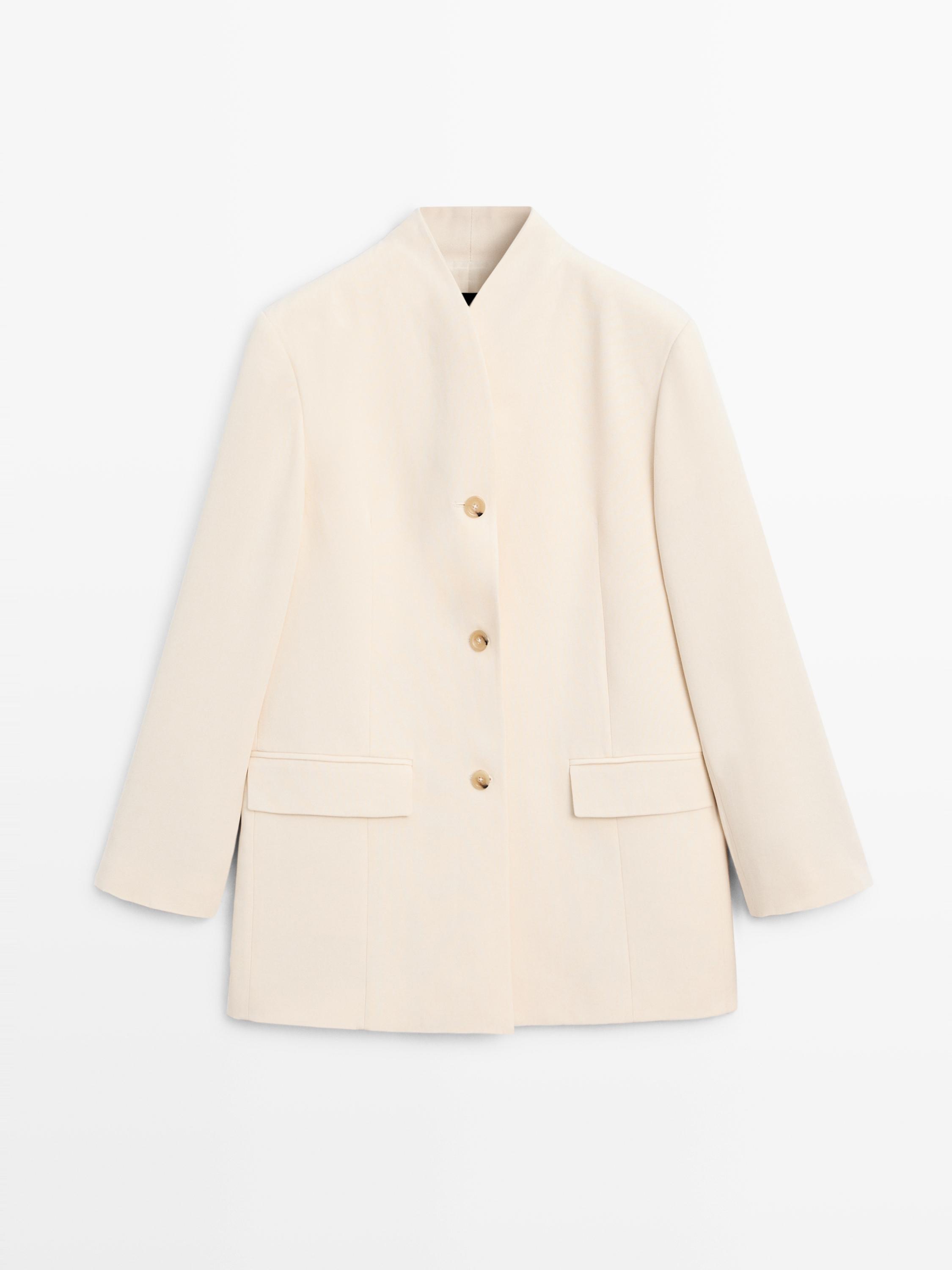 Front view of a raw blazer with a stand-up collar, central button placket, and front flap pockets.