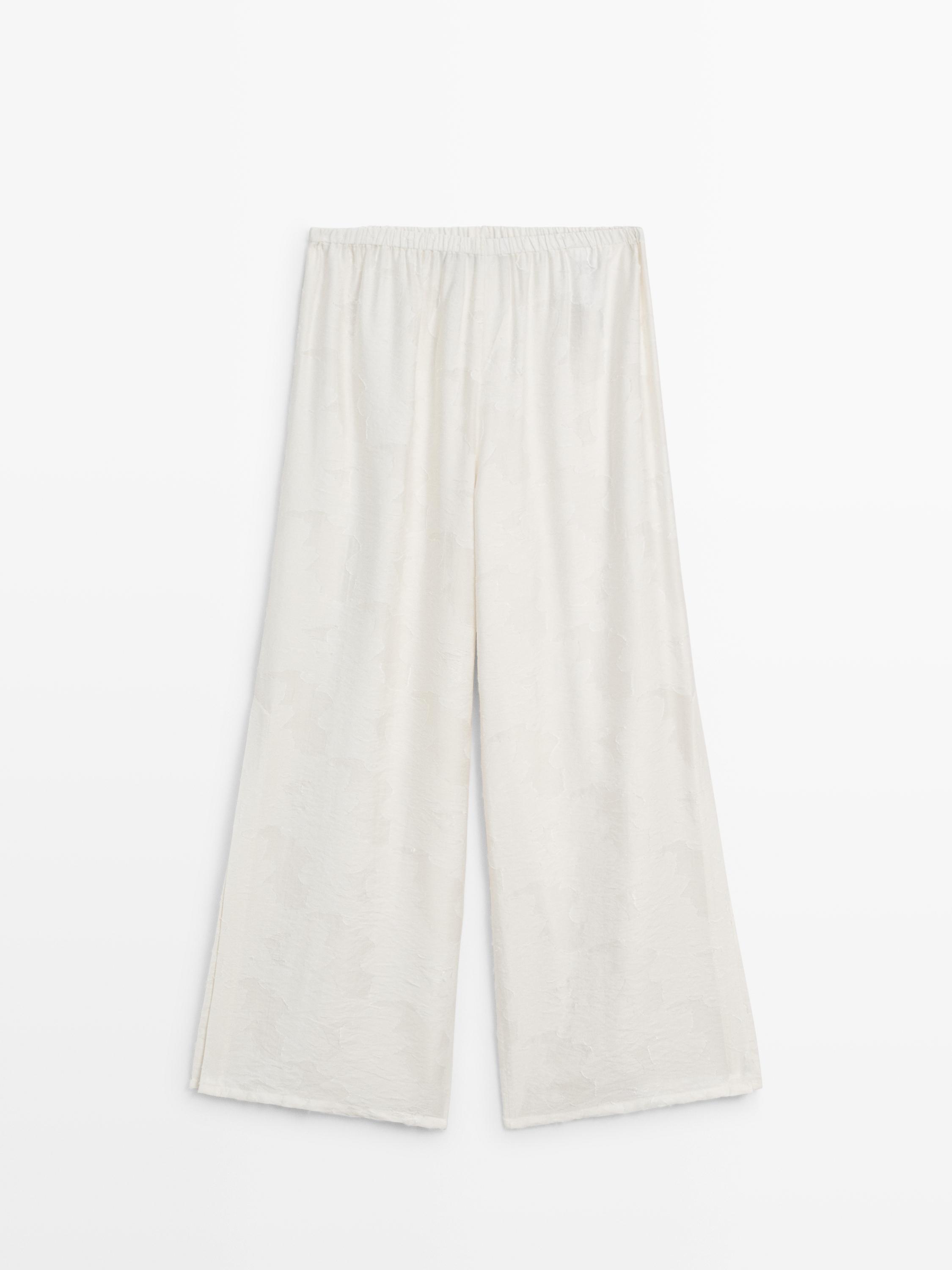 Flowing stretch trousers with fabric detail