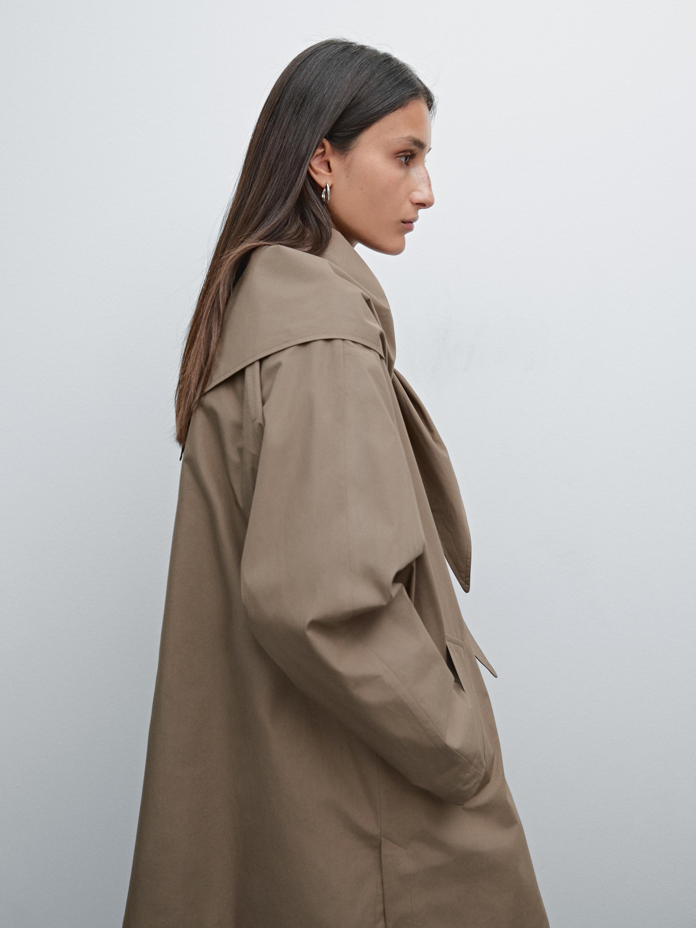 Trench coat with detachable scarf detail