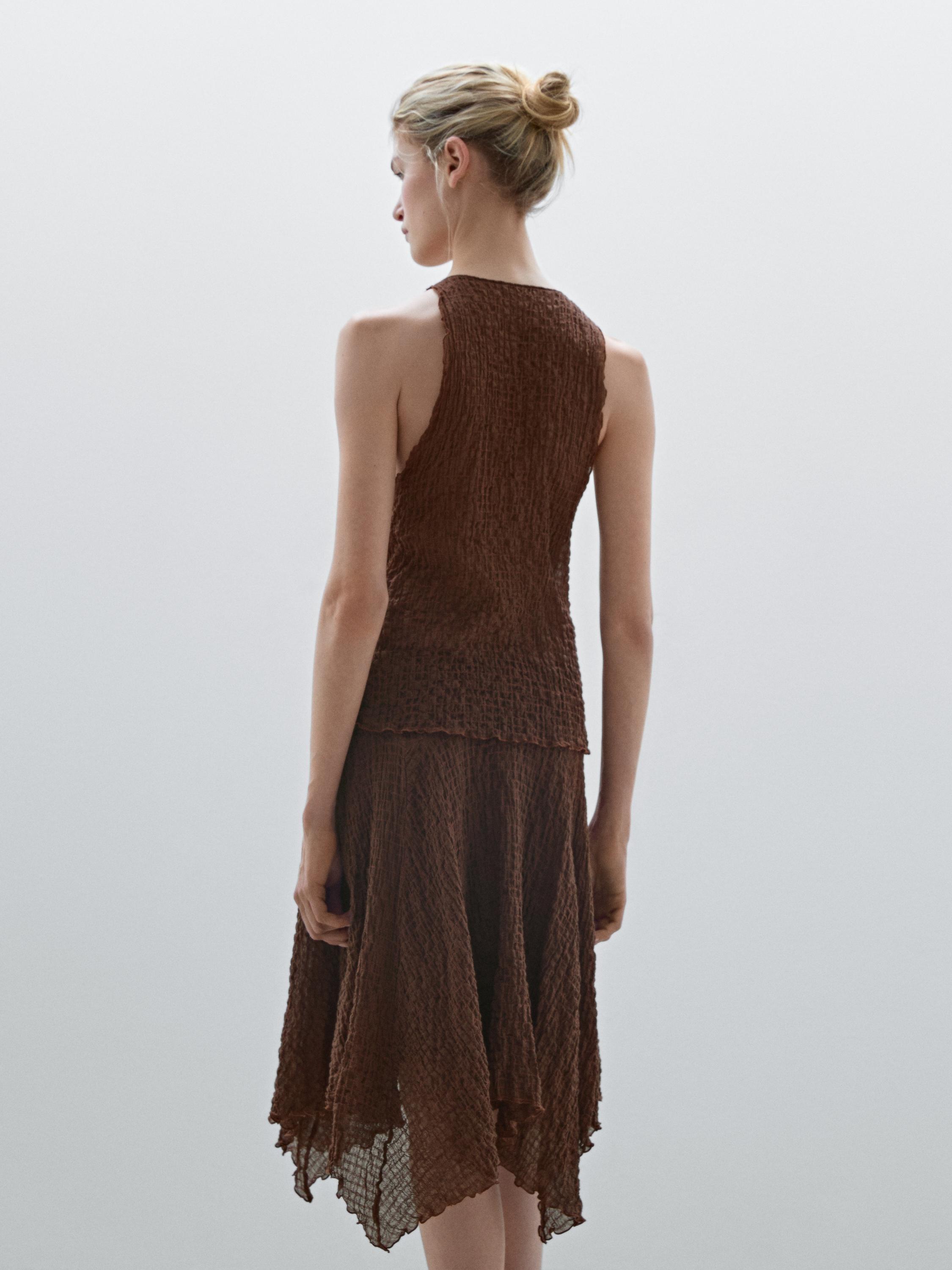 Flowing check skirt with asymmetric hem