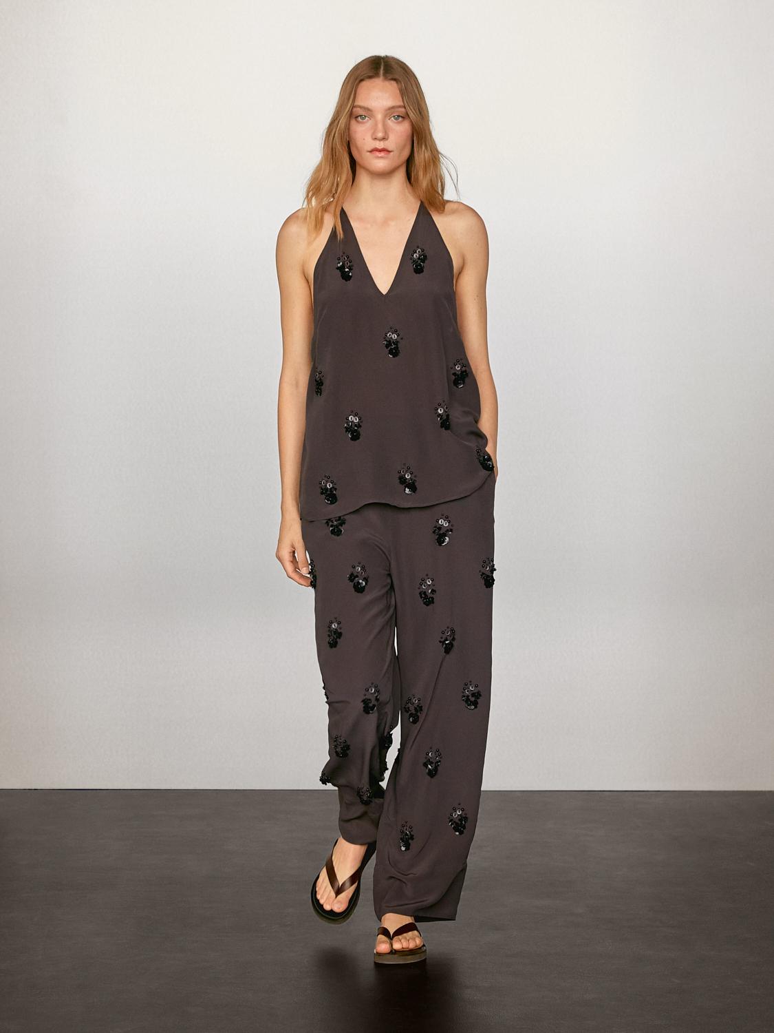 Flowy top with floral appliqués