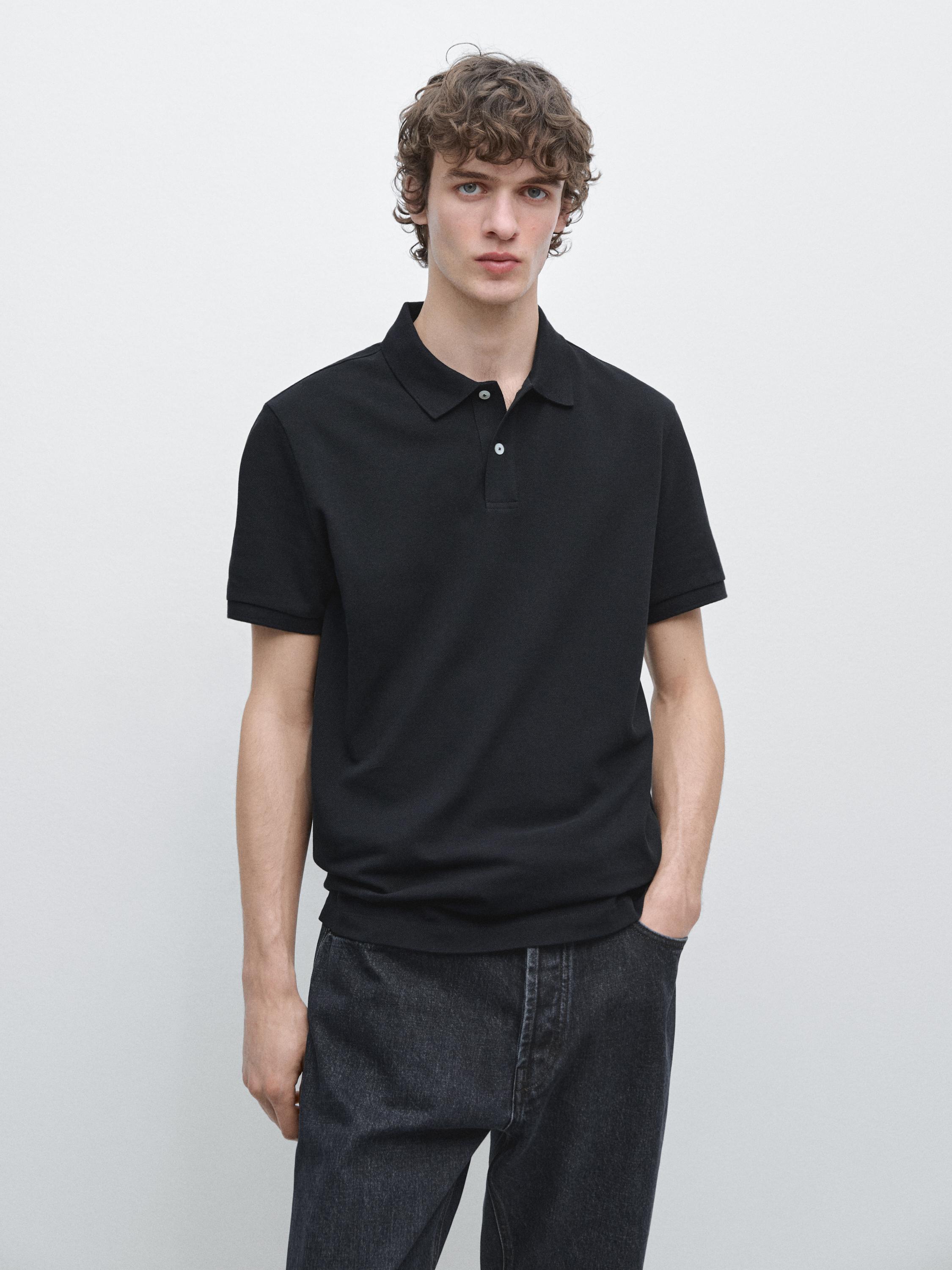 Navy blue short-sleeved polo set with a classic collar and buttons, paired with dark pants.