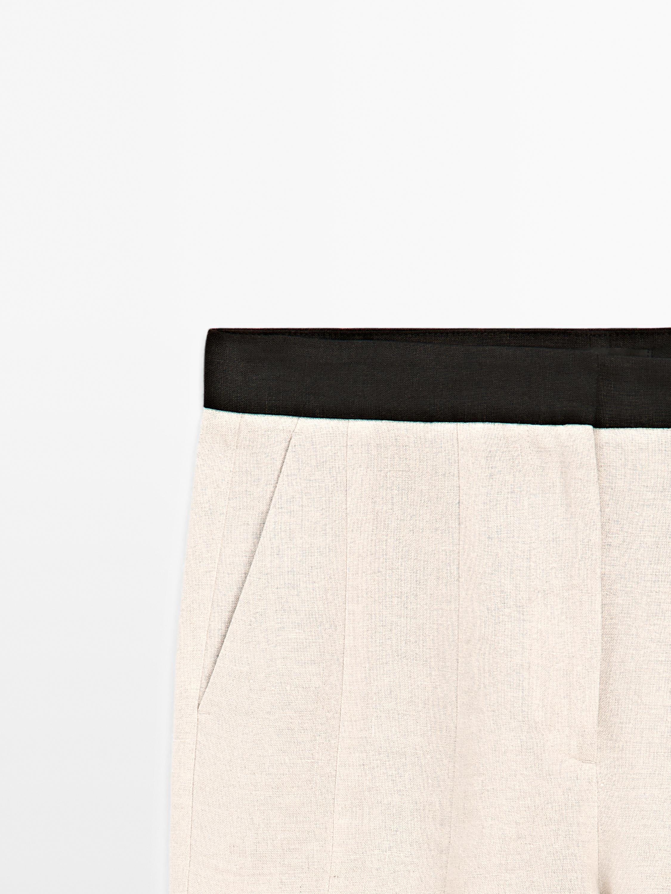 Flared trousers with contrast waist