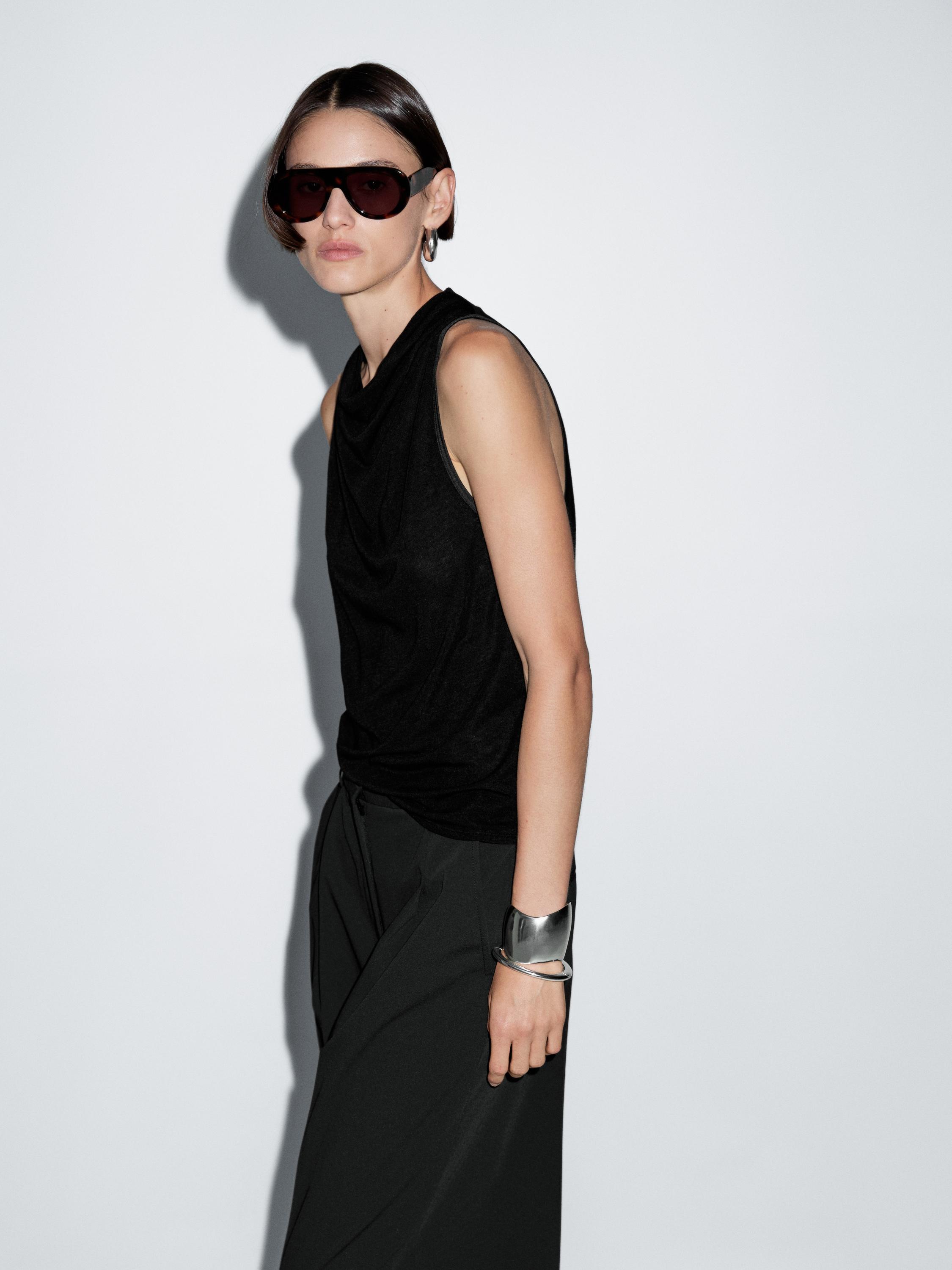 Sleeveless top with draped neckline