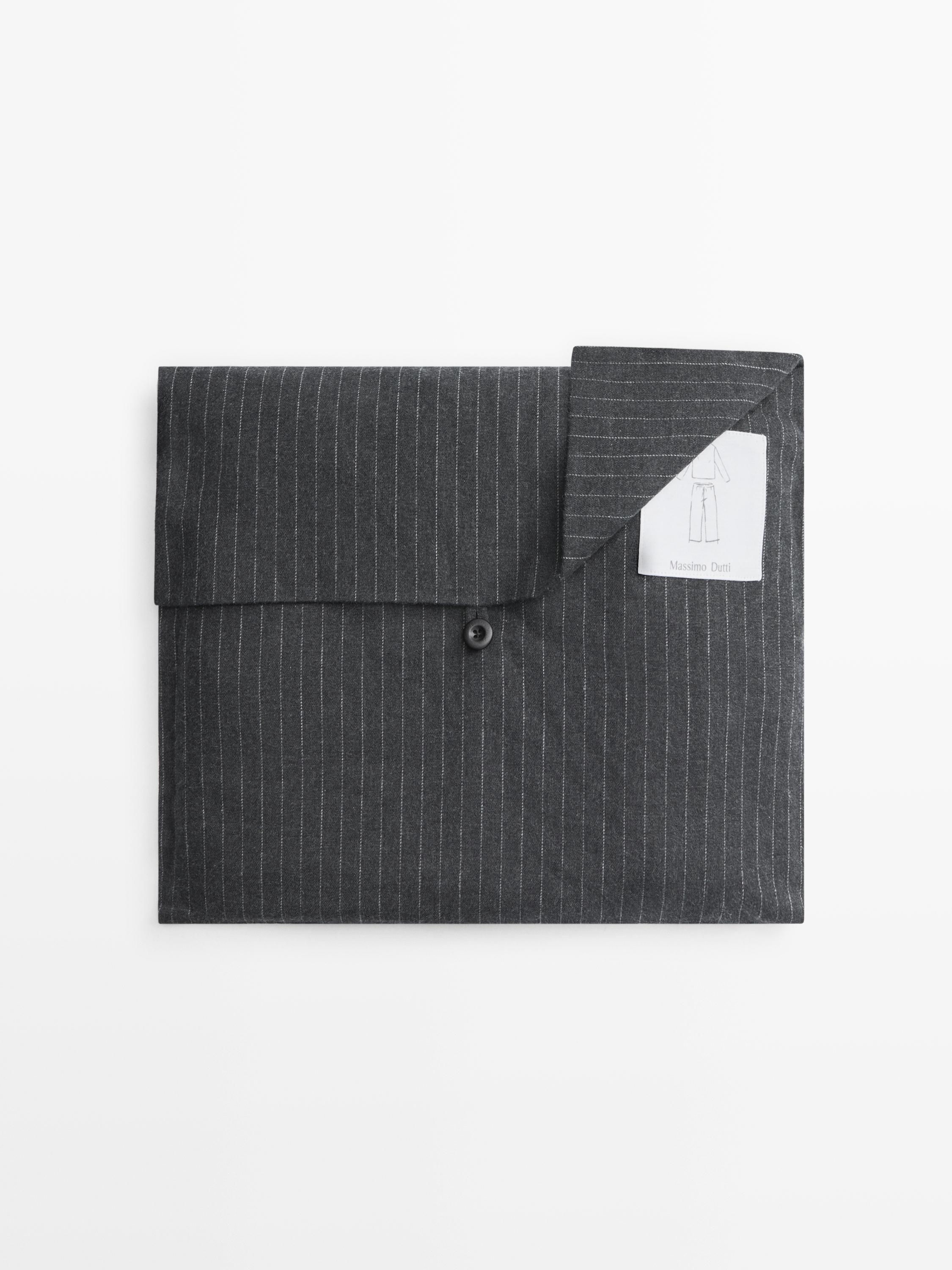 "Front view of gray pajamas with thin stripes and visible button."