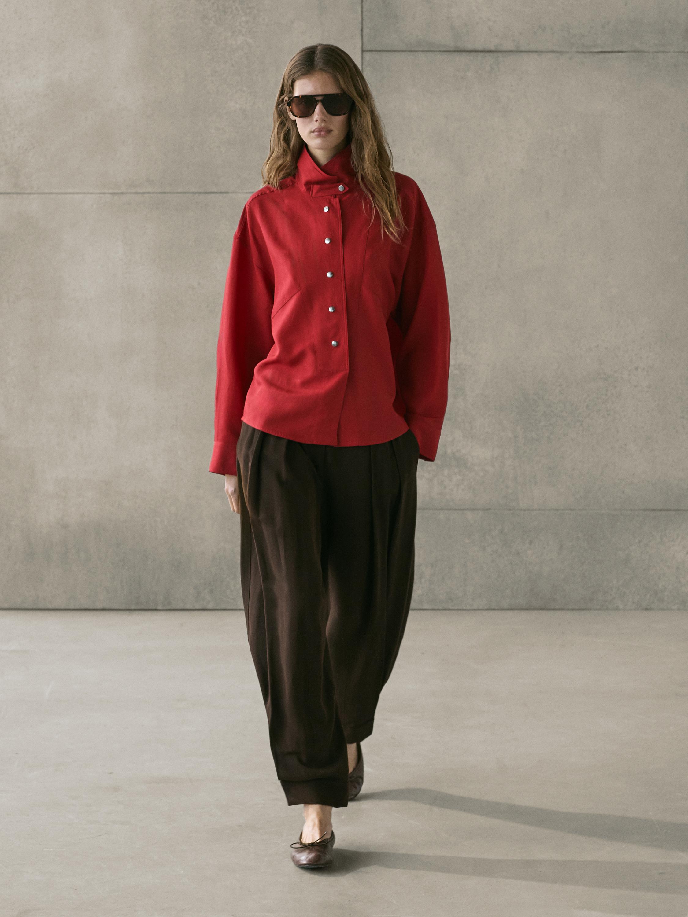 Red snap-button shirt set with loose brown pants.