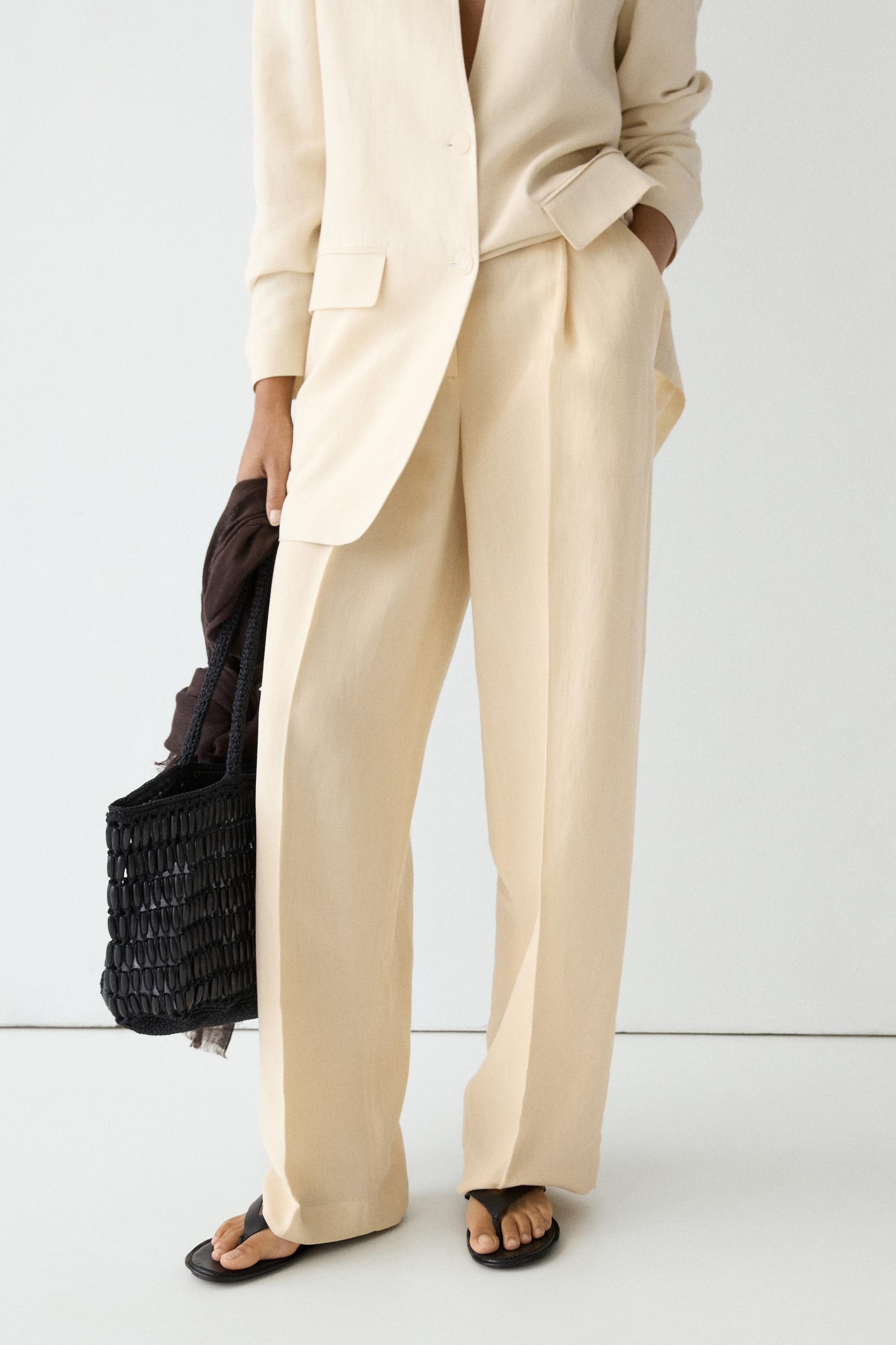 Flowing trousers with pleats — Beige