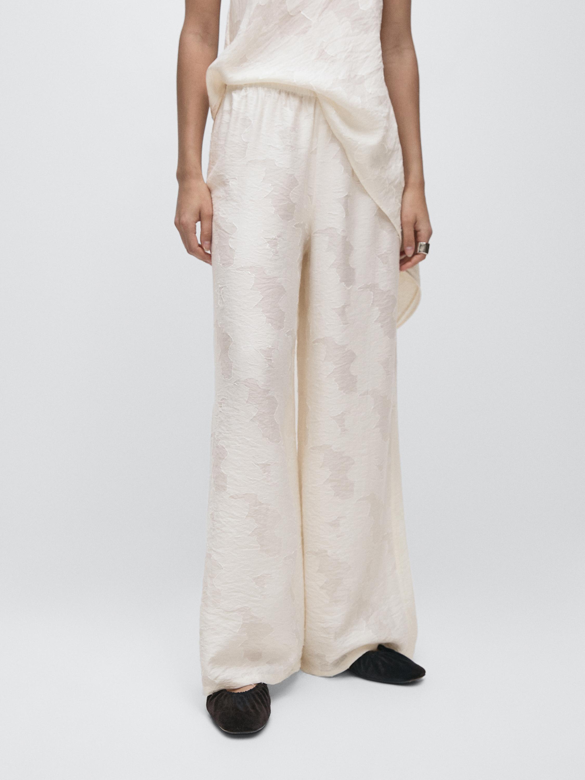 Flowing stretch trousers with fabric detail