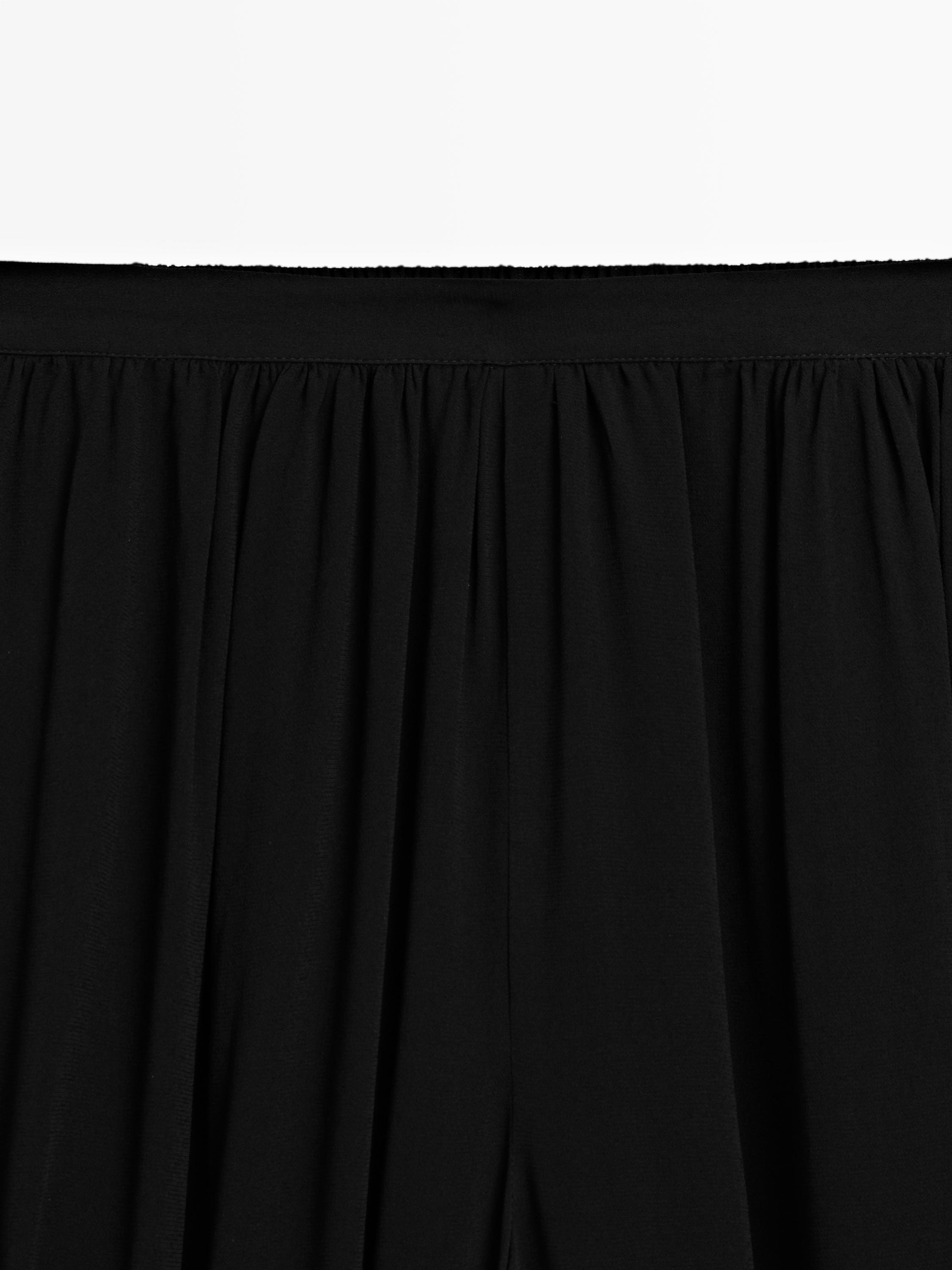 Semi-sheer sarouel trousers with button details — BLACK