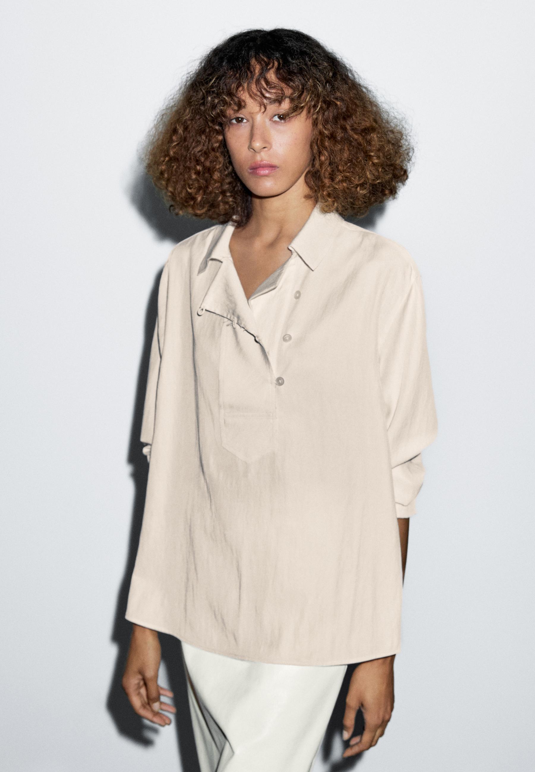 Blusa fluida com pormenor de abotoadura