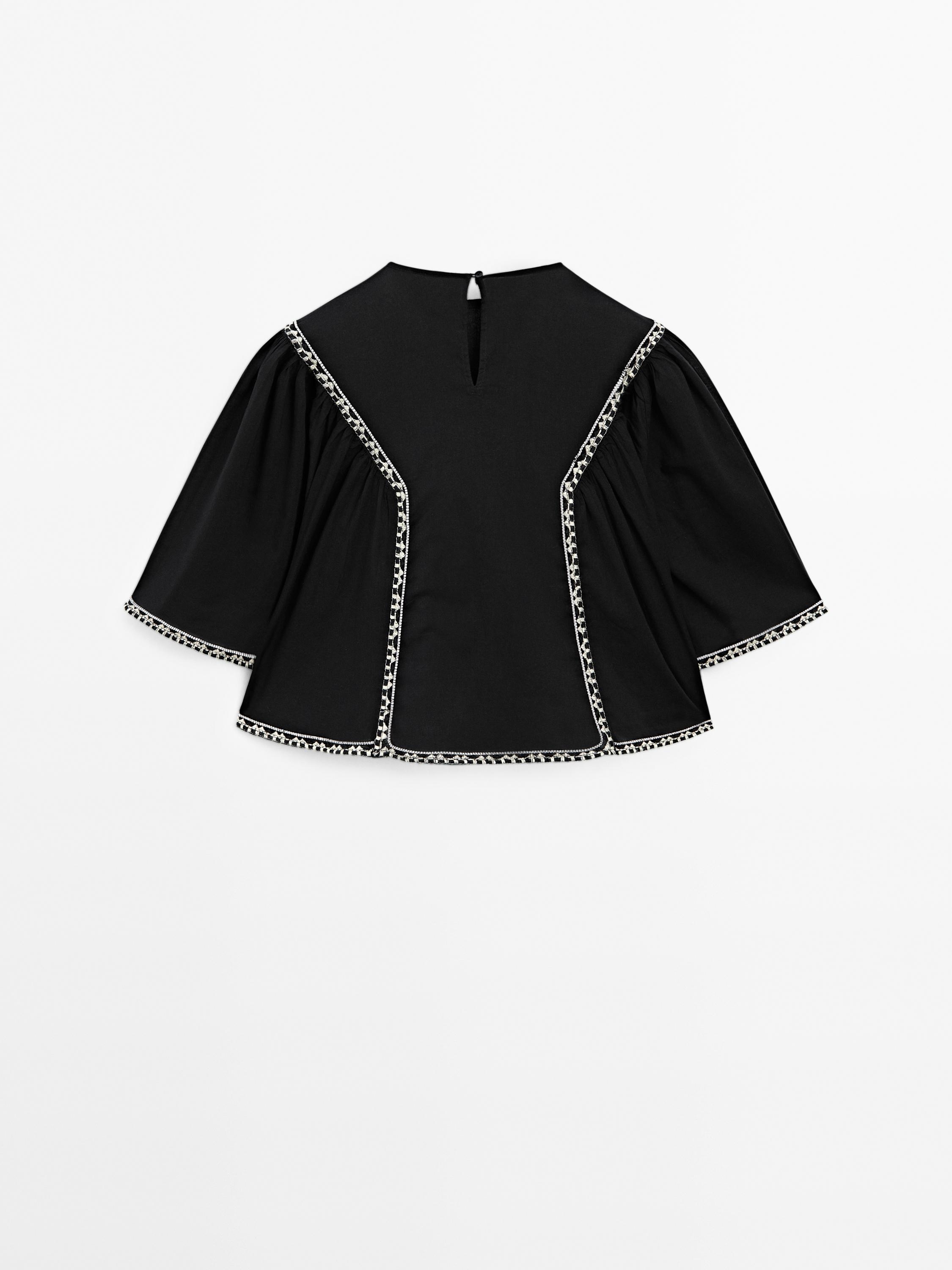 Flowing blouse with embroidered details