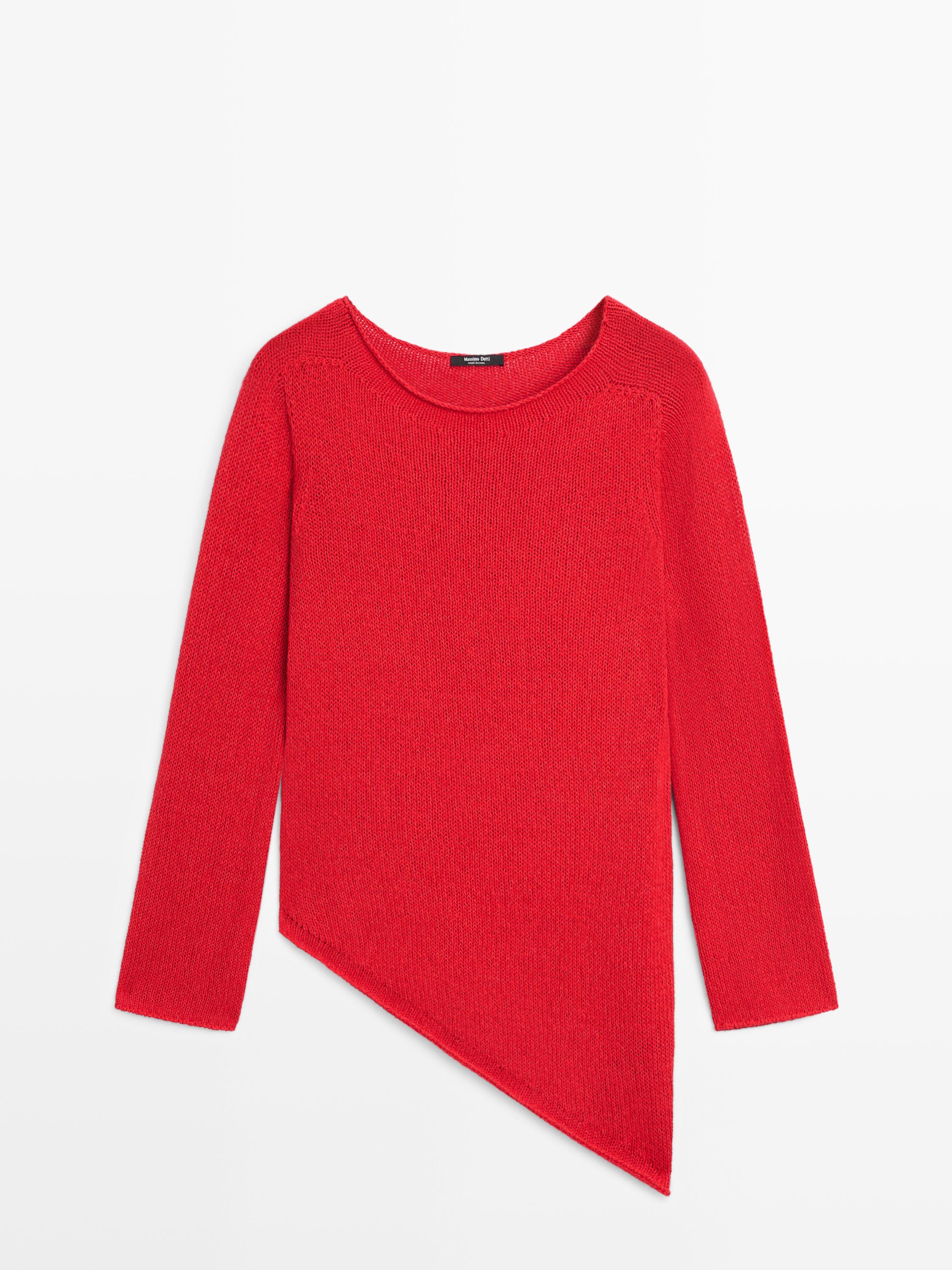 Front view of red knit sweater with asymmetrical cut and long sleeves.