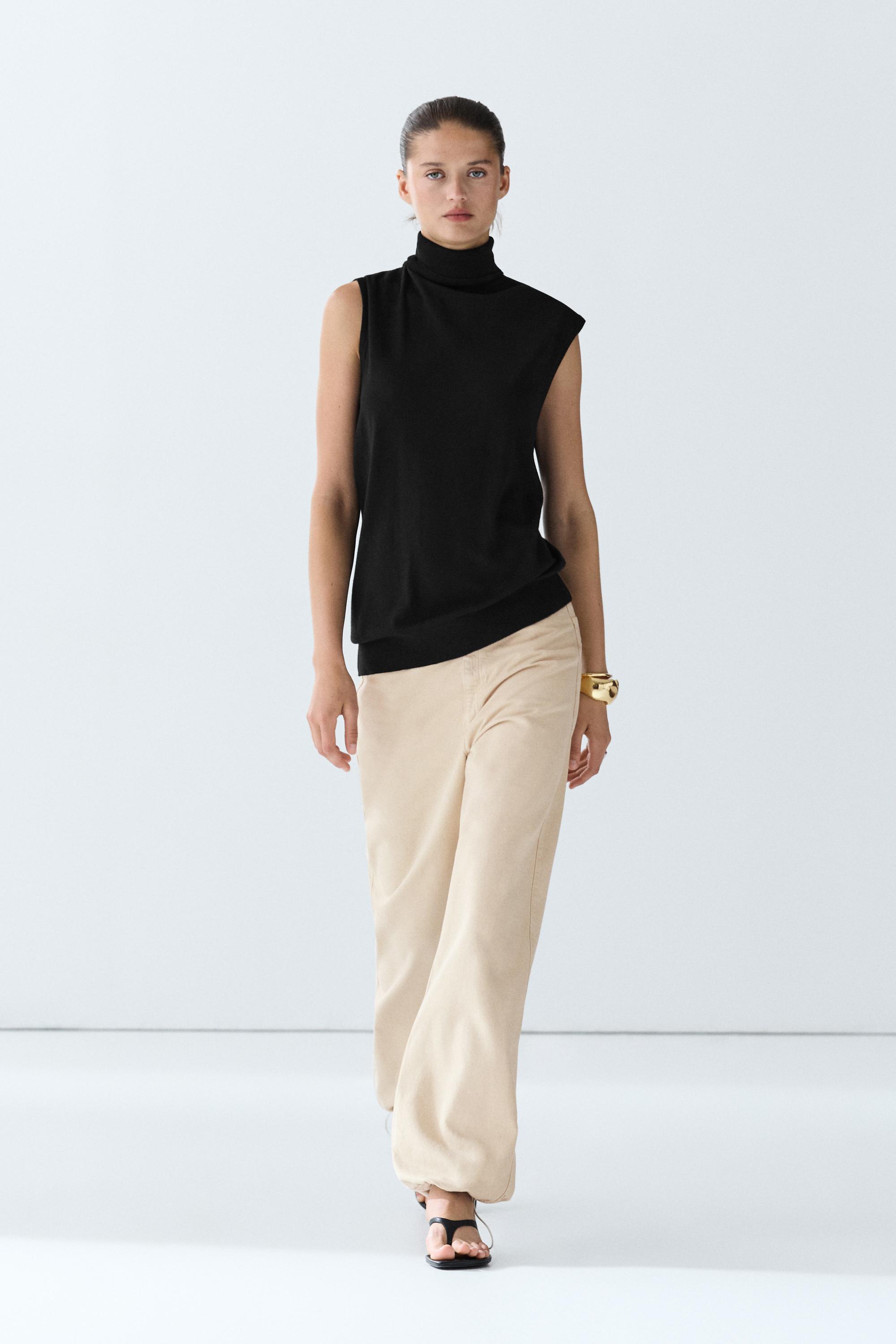 Asymmetric hem turtleneck top — BLACK