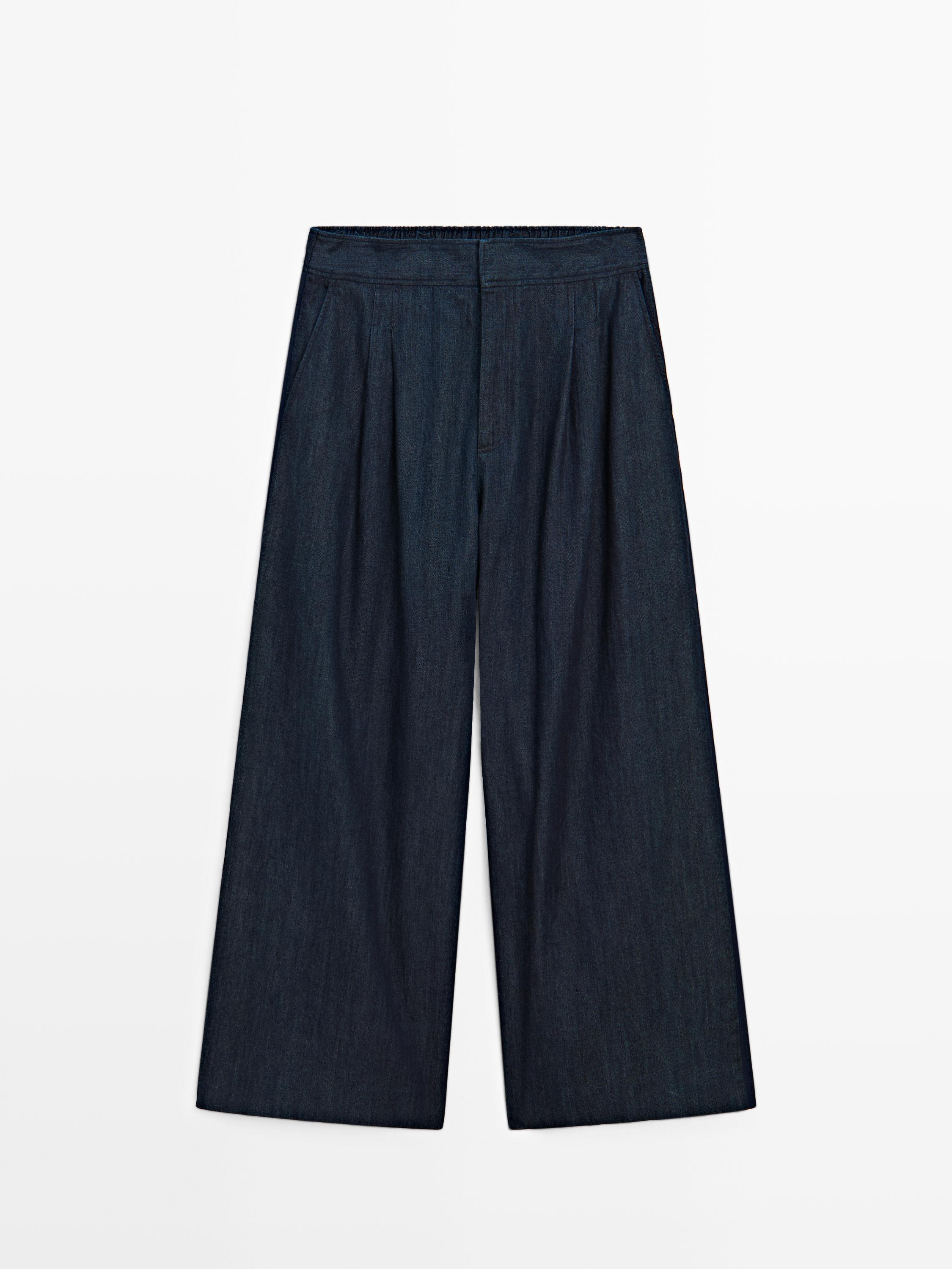 جينز بساق عريضة وتفاصيل بكسرات