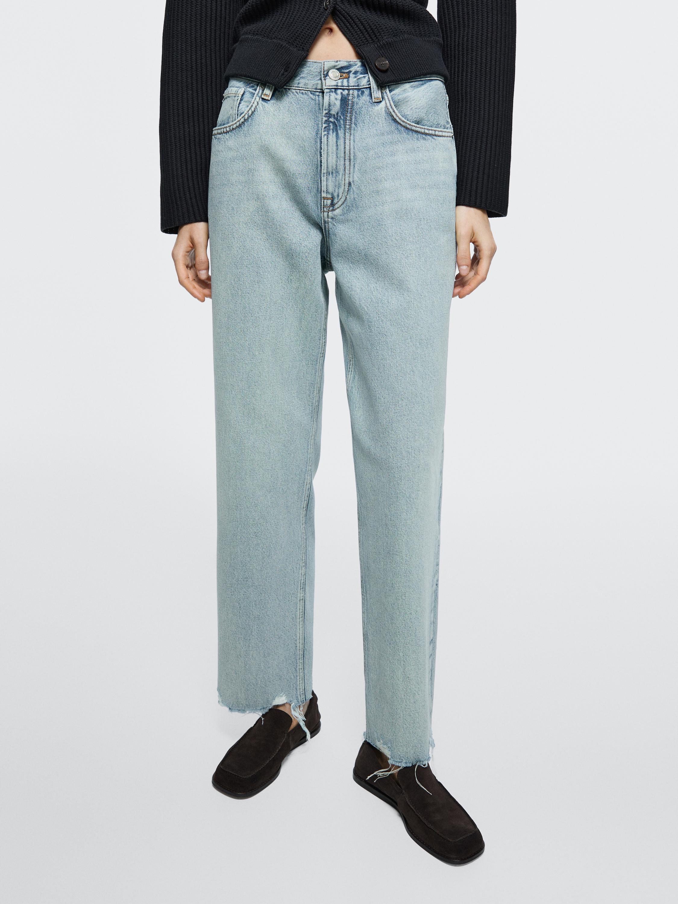 Light blue high-waisted straight-leg jeans with distressed hems and front pockets.