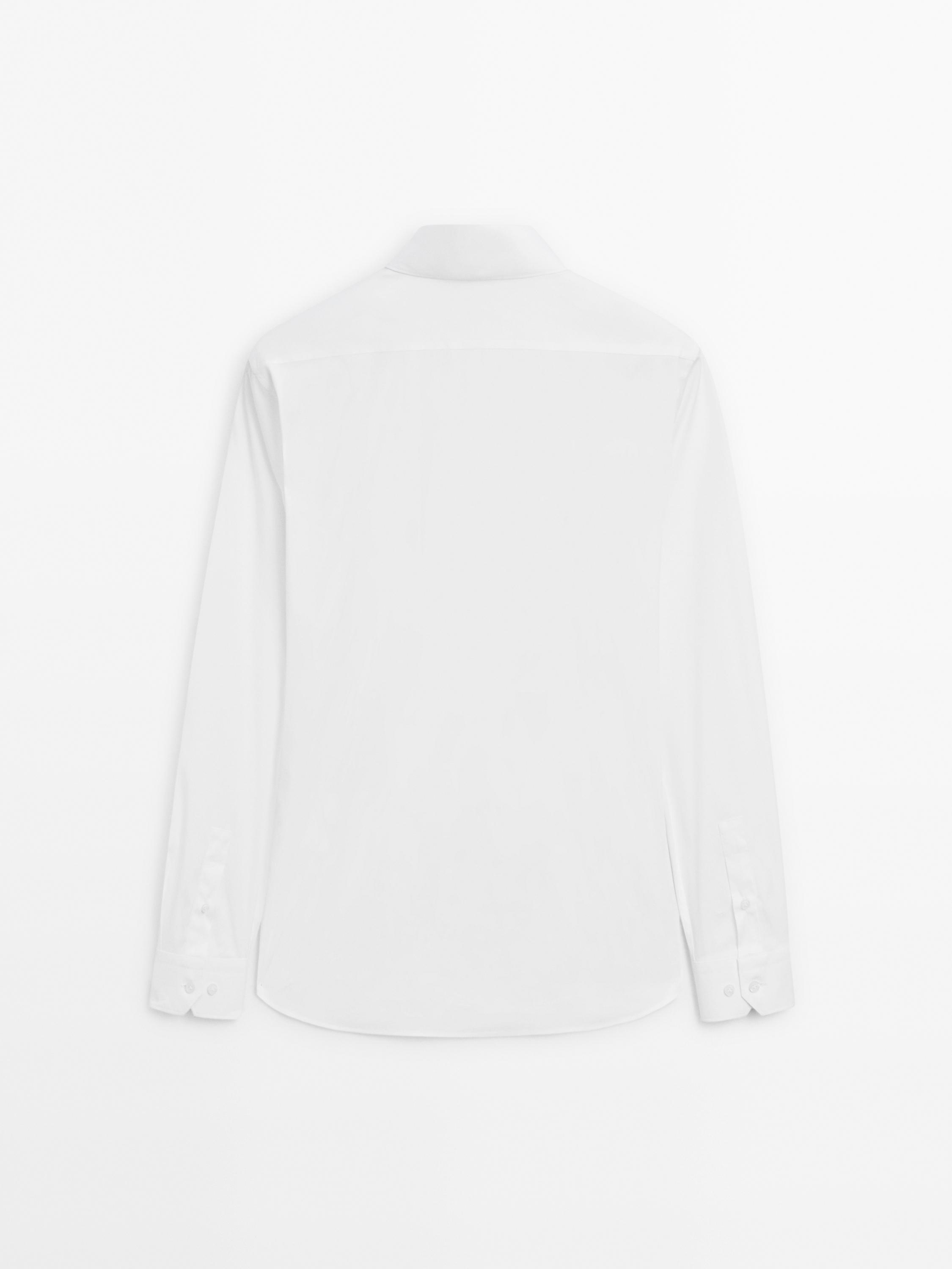 Rear view of white long-sleeve shirt with buttoned cuffs and a slim fit.