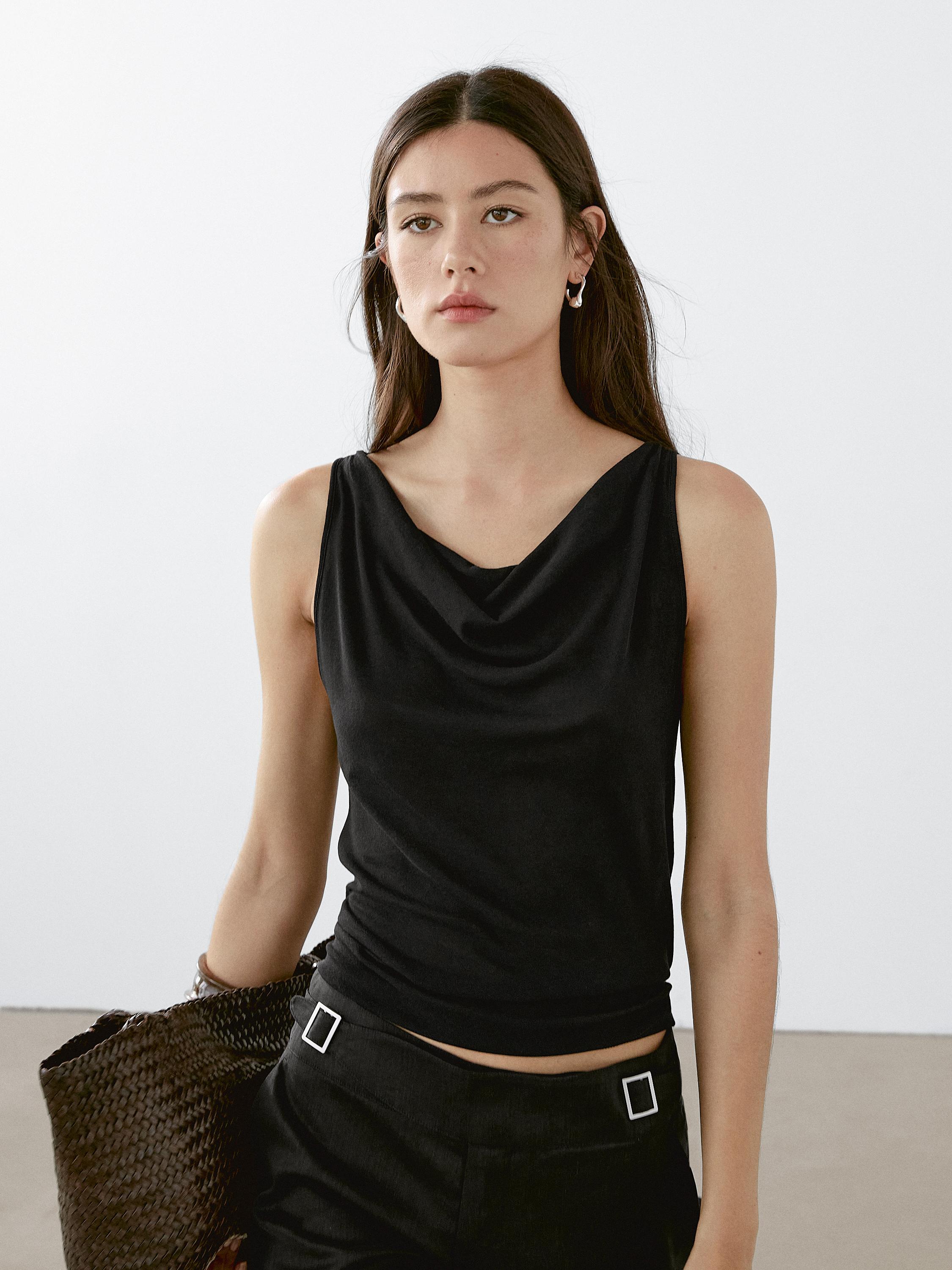 Sleeveless top with draped neckline