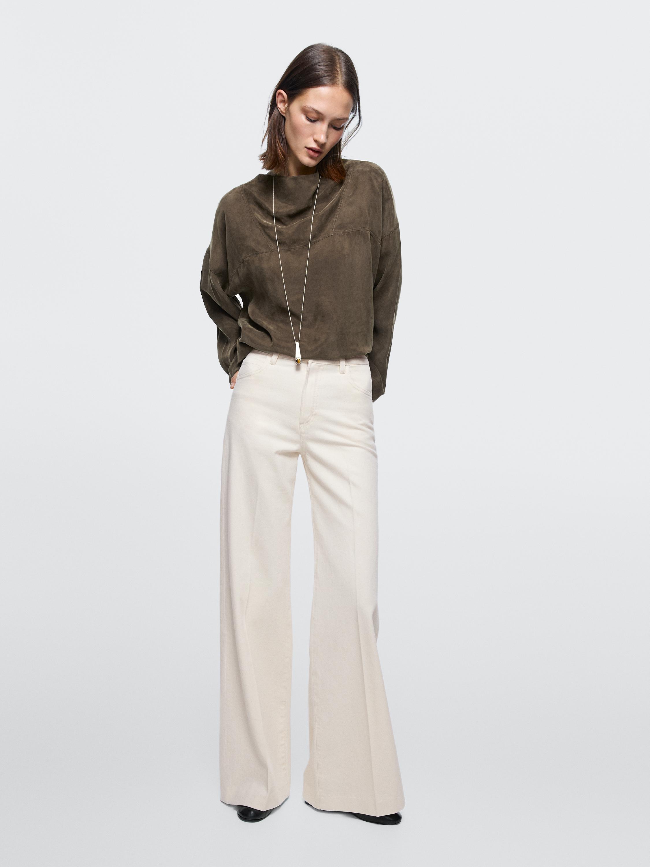Long-sleeve brown blouse and high-waisted palazzo jeans set.