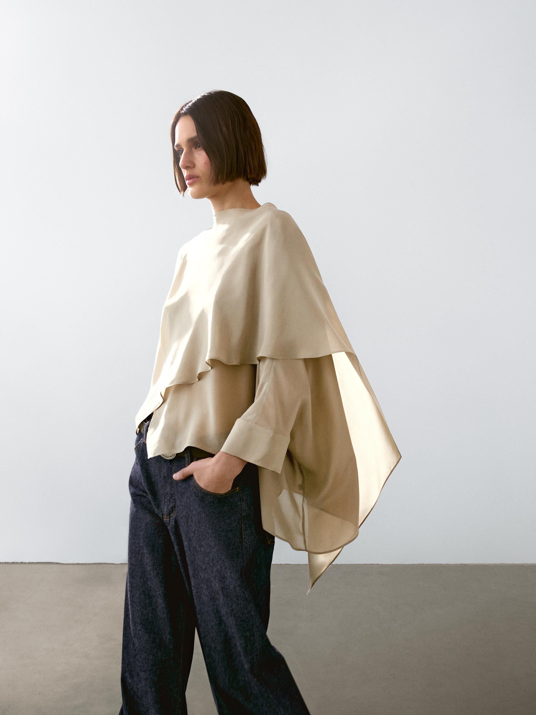 Flowing cape with a satin finish