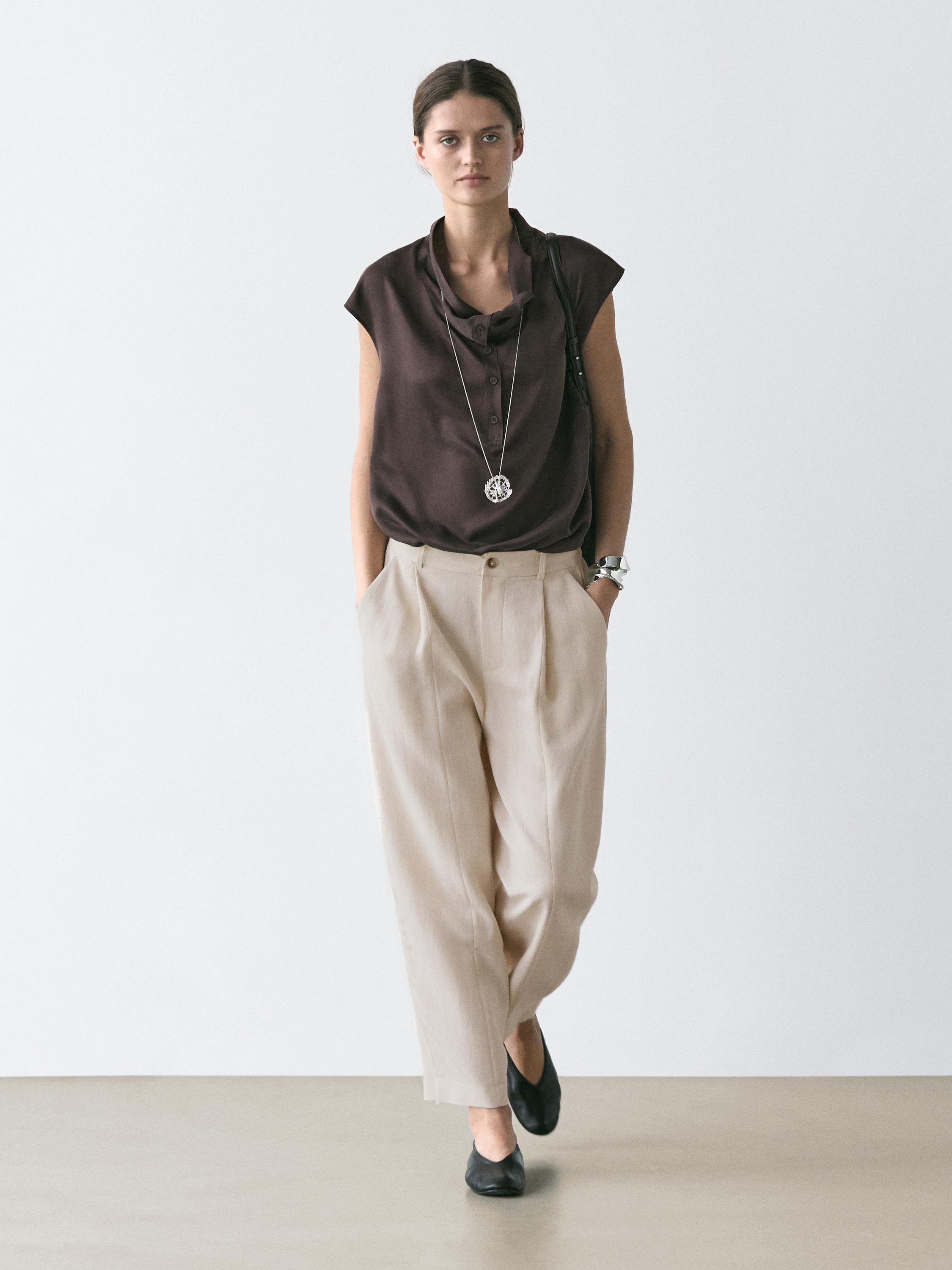 Brown blouse set with a draped neckline and flowy pants with an elastic waist and side pockets.