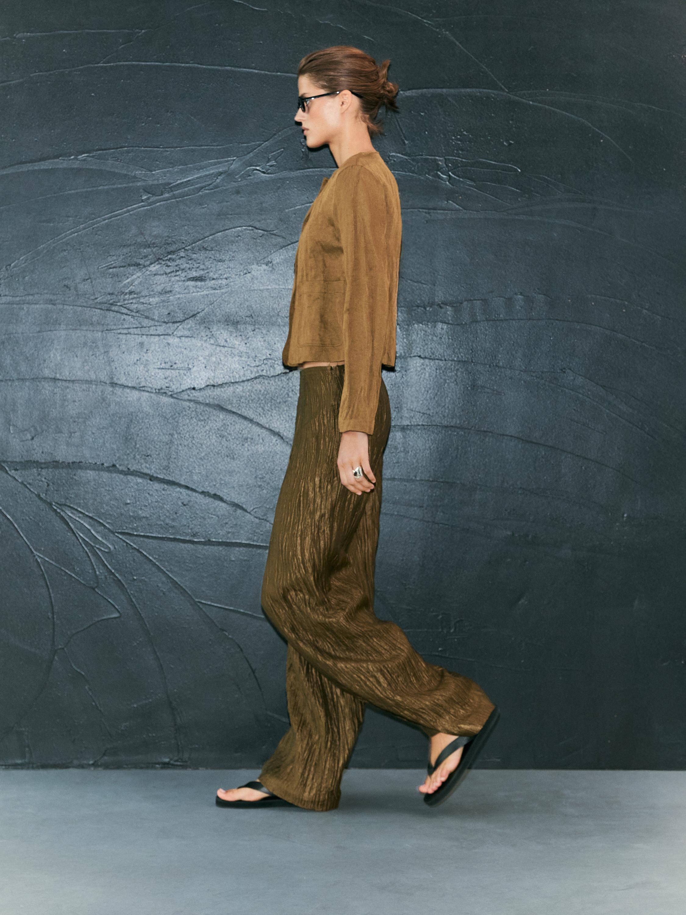 Trousers with metallic fabric detail