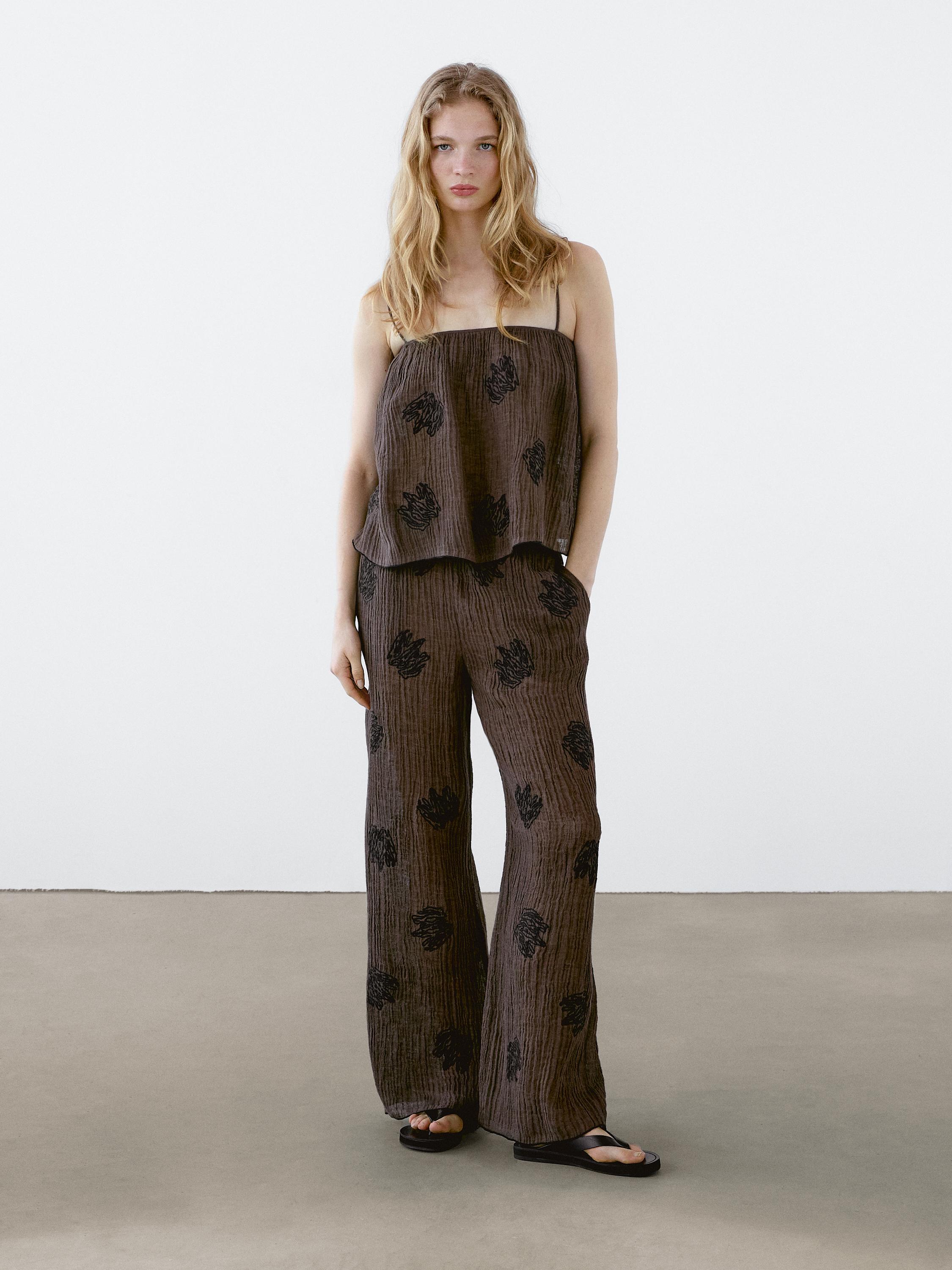 Flowing textured trousers with embroidered detail