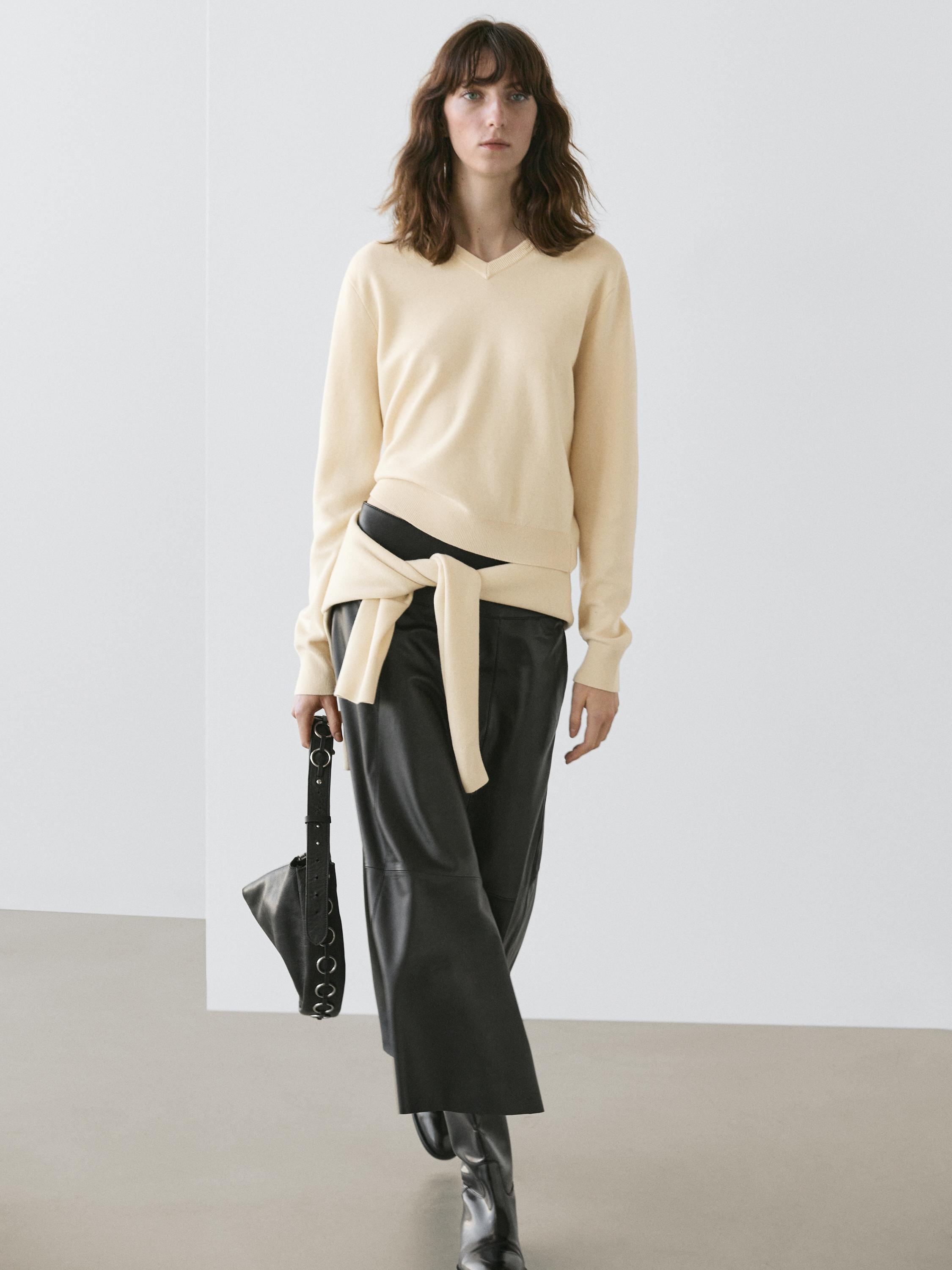 Vanilla V-neck sweater and black wide-leg pants set.