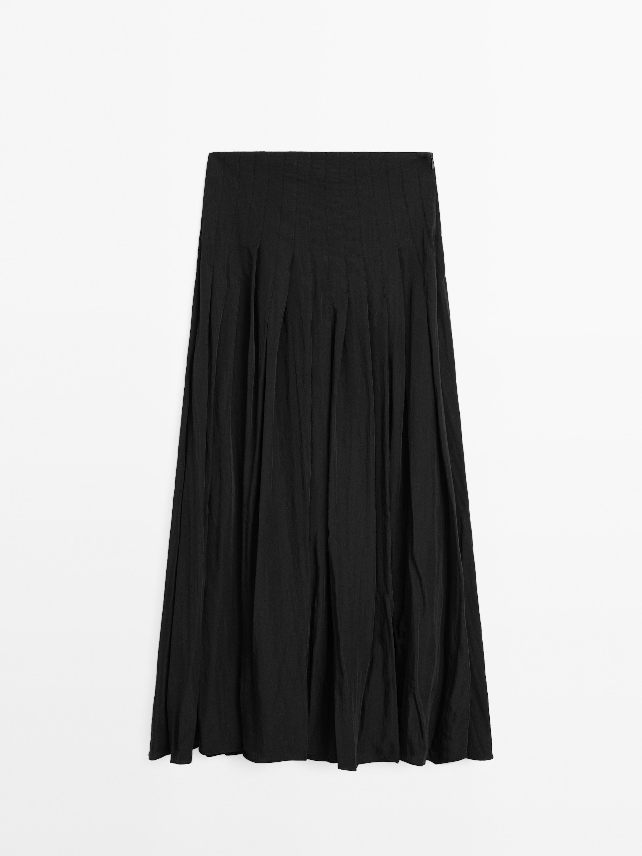 Soepelvallende midirok met bandplooien