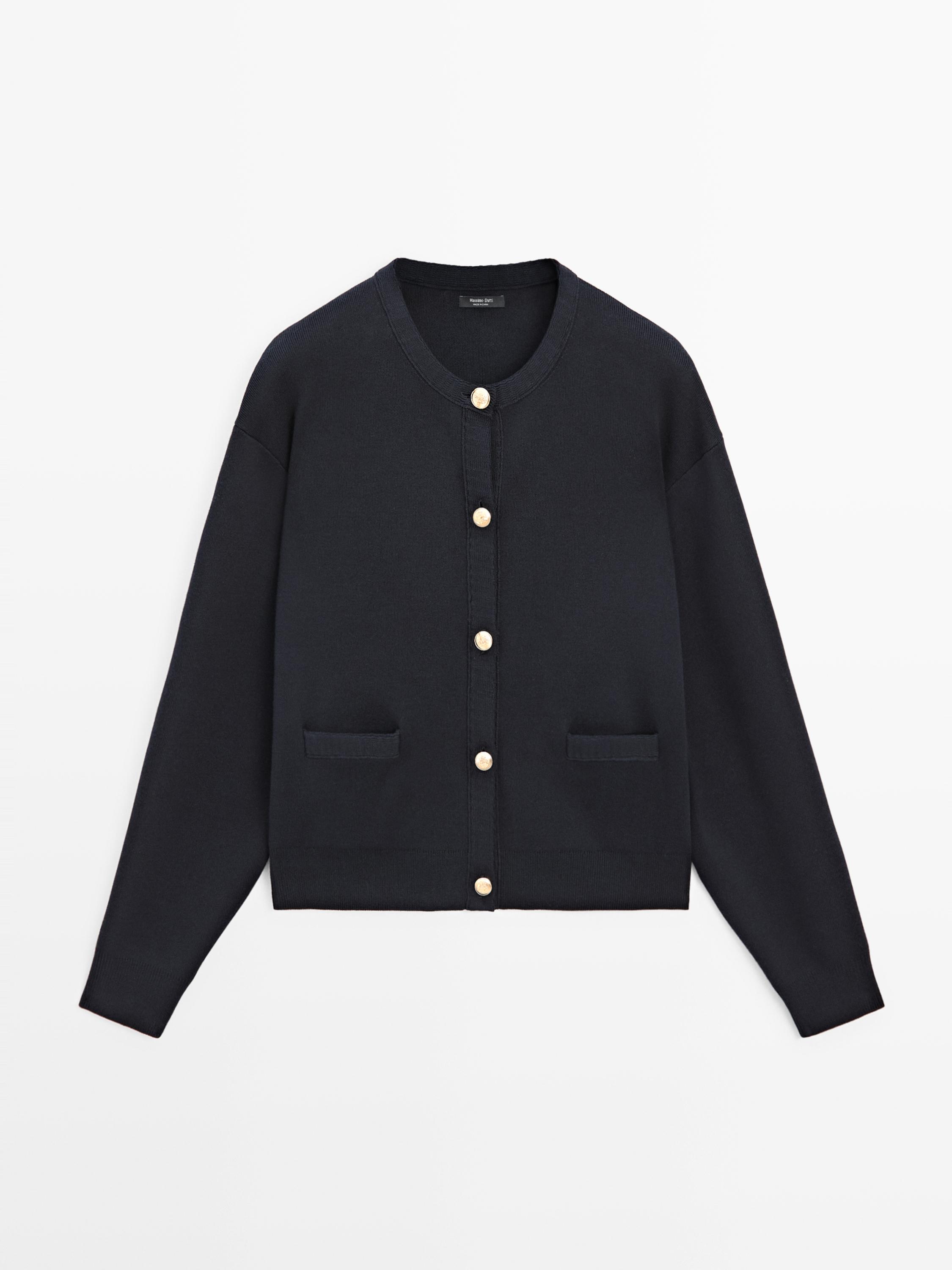 Front view of navy blue cardigan with gold buttons and front pockets.