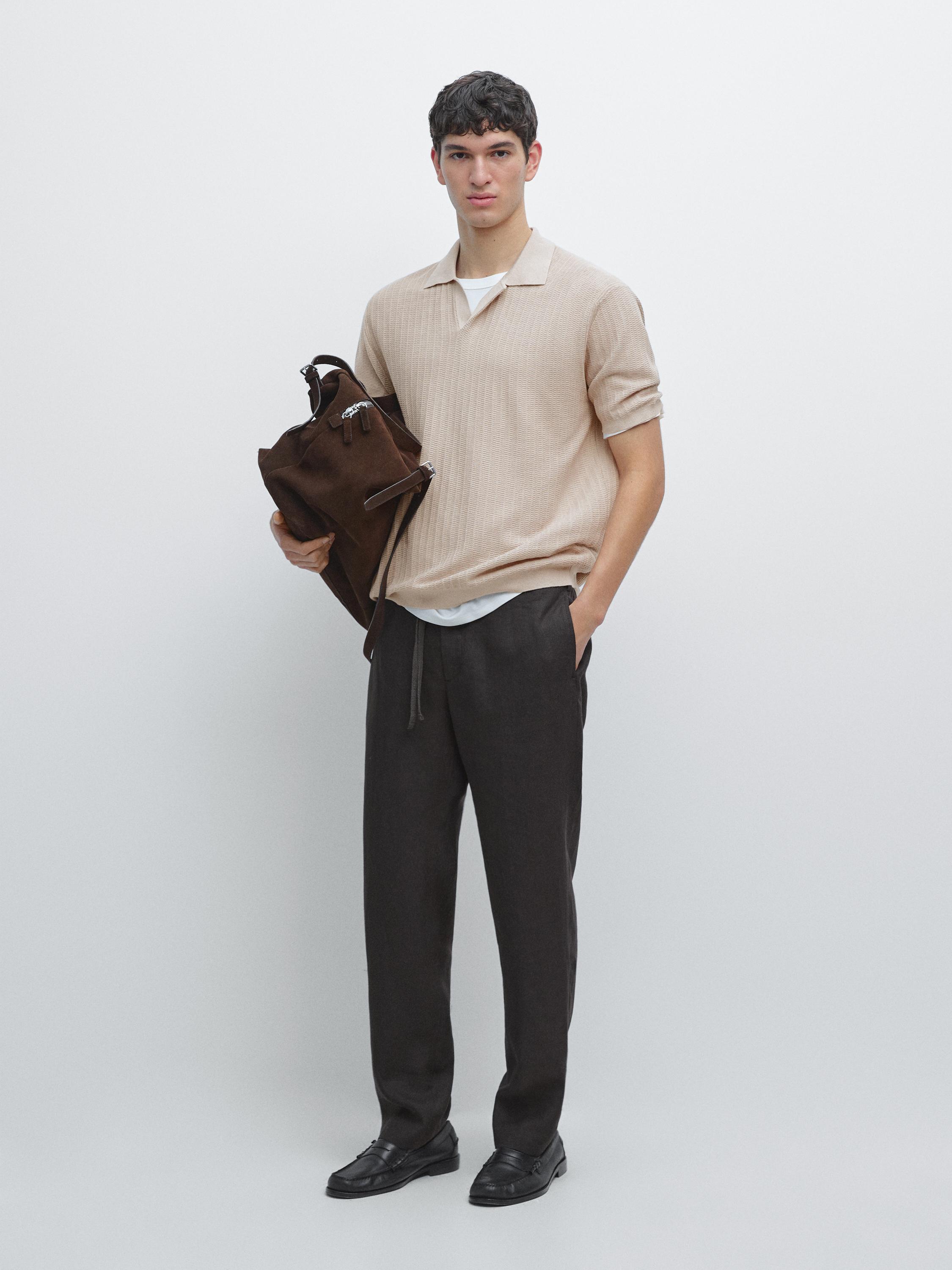 Short-sleeved sand polo set and dark pants with side pockets.