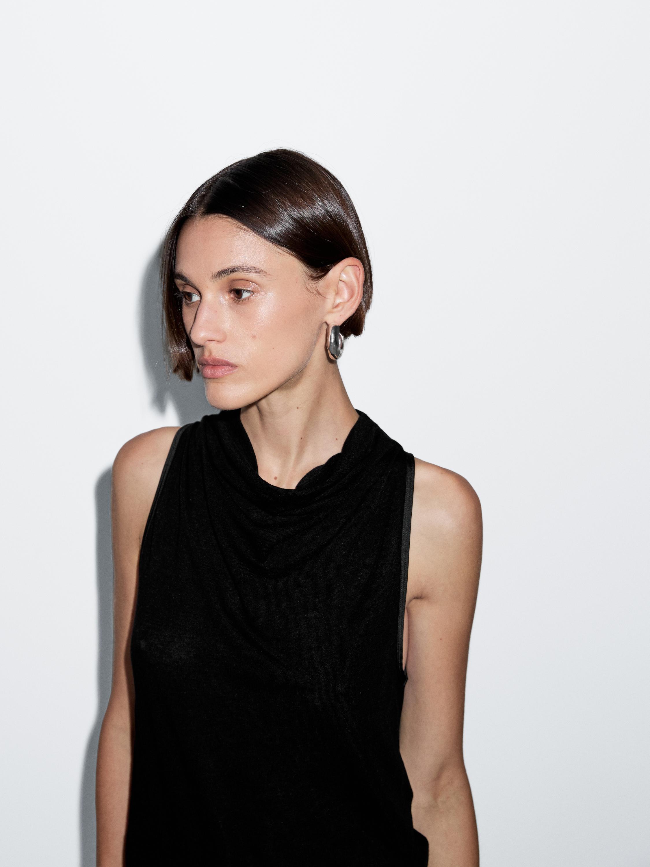 Sleeveless top with draped neckline