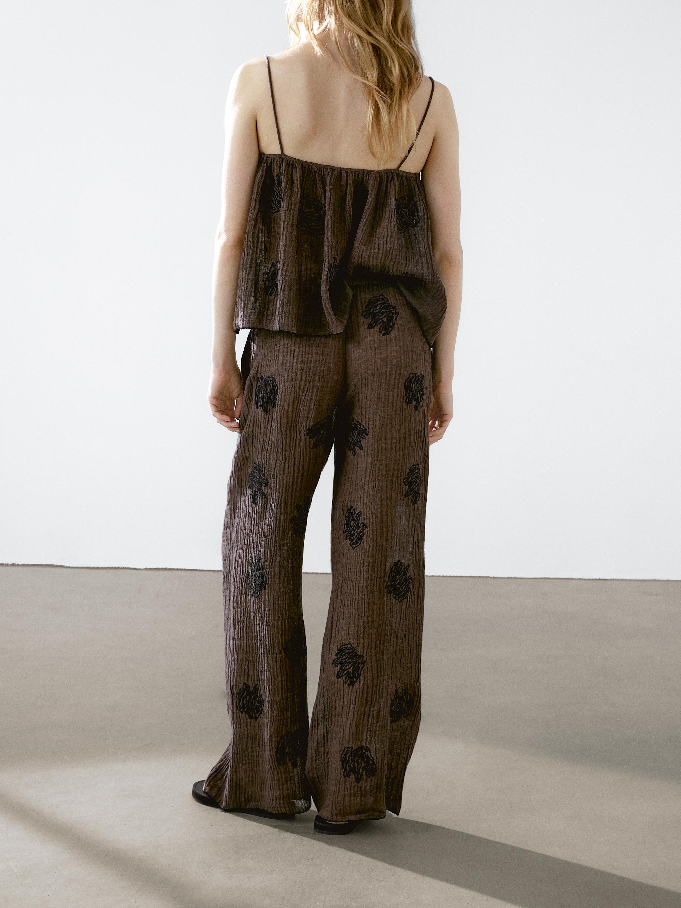 Flowing textured trousers with embroidered detail