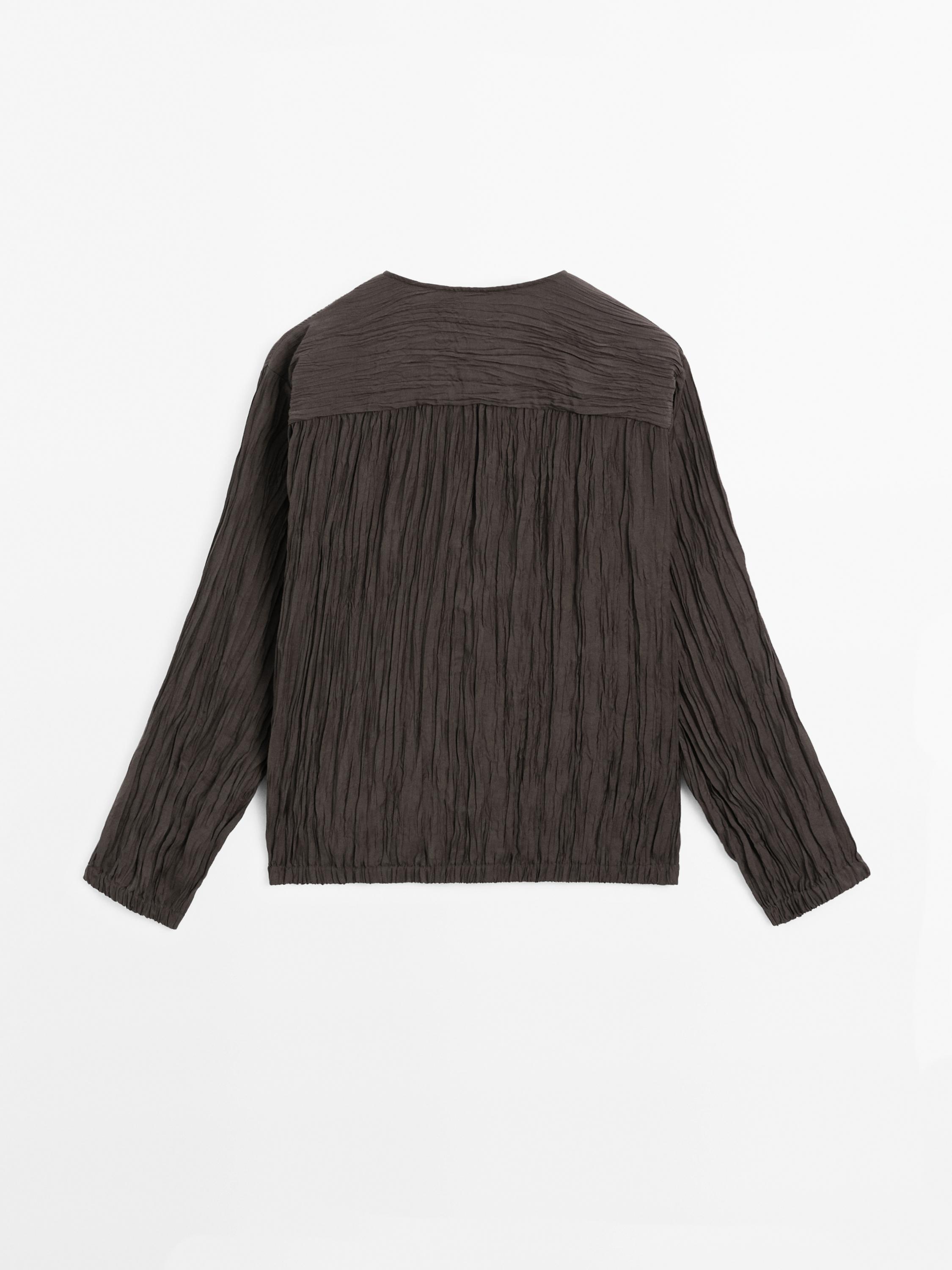 Flowing pleated bomber-style shirt