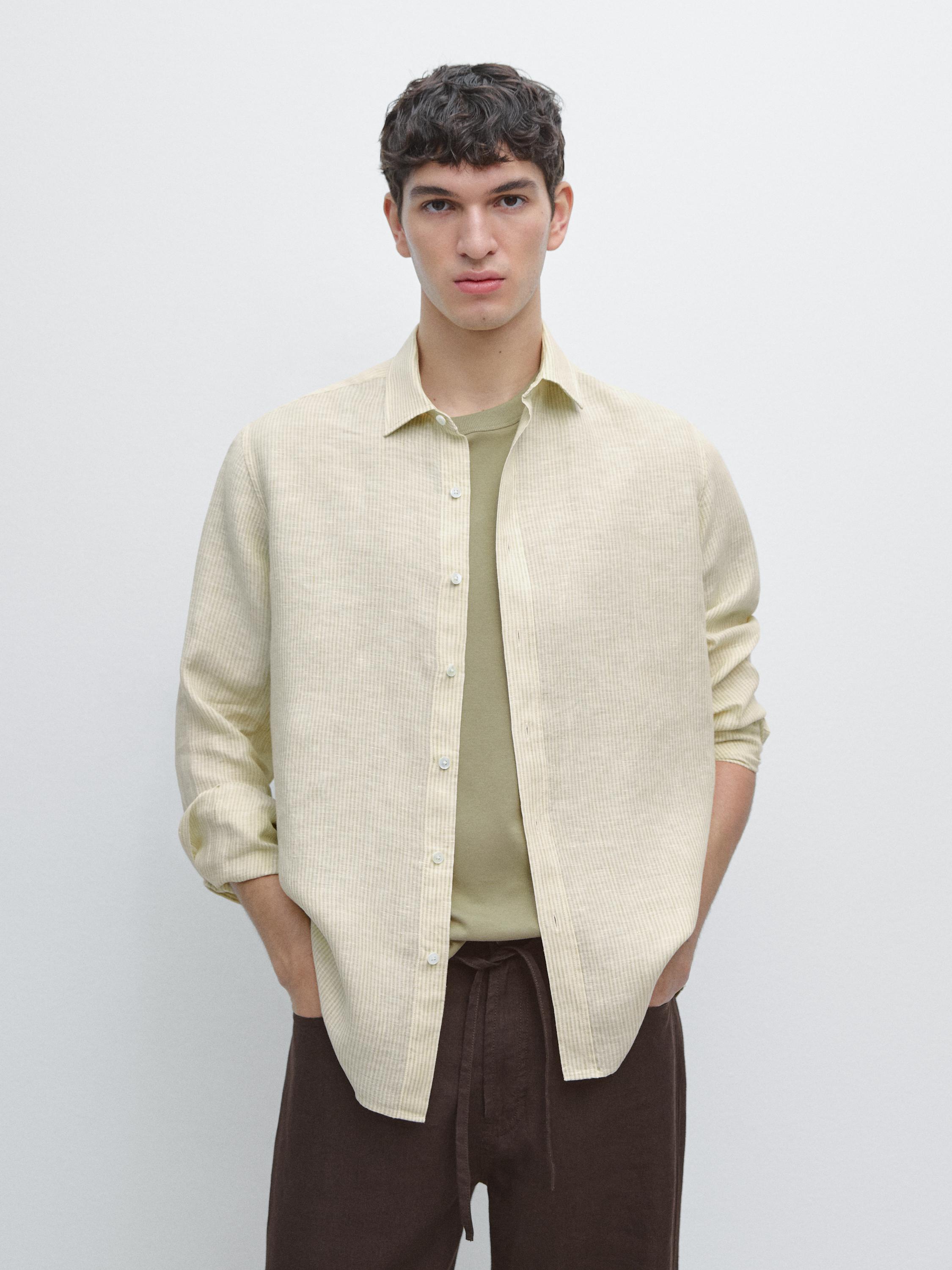 Striped beige button-down shirt set with a green t-shirt underneath, brown pants with a visible drawstring.