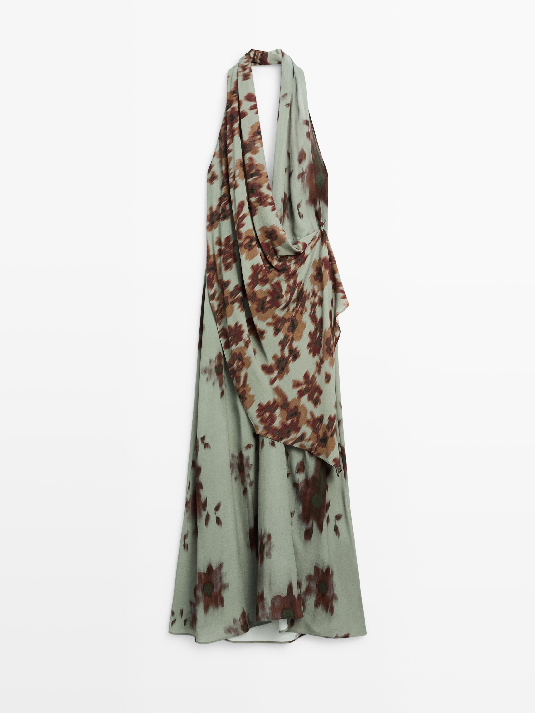 Front view of an aqua green mini halter dress with a brown floral print and a draped neckline.