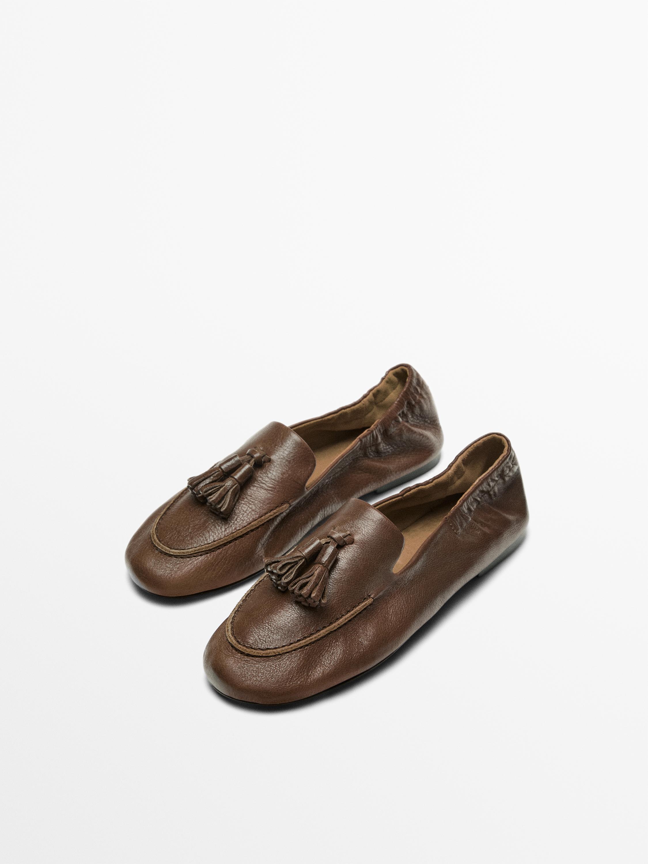 Mocassin en cuir à pompons