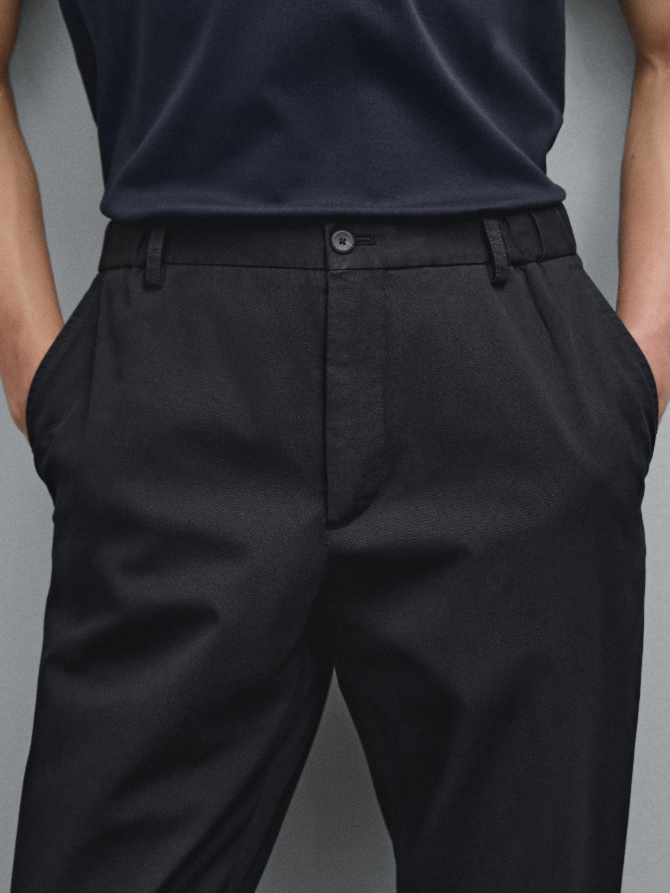 Tapered fit trousers with side elastic detail