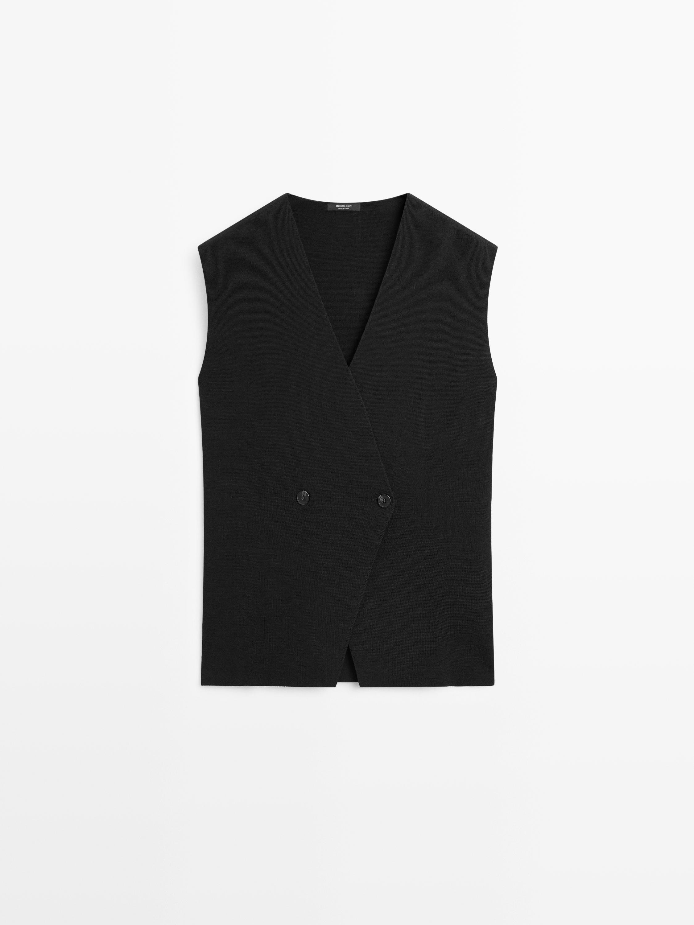 Front view of a long black vest with a crisscross detail and two visible buttons.