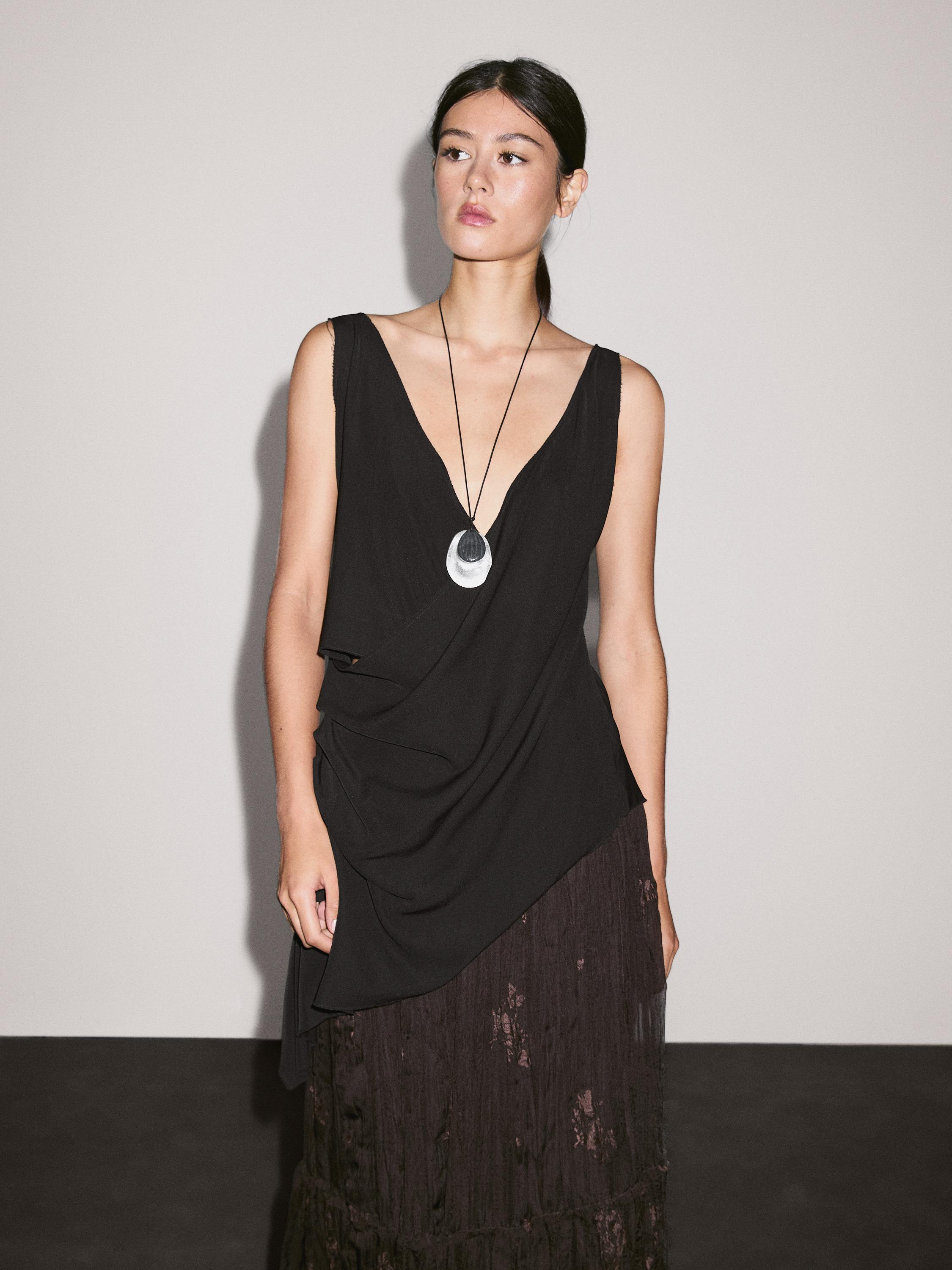 Long pleated skirt with embroidered detail