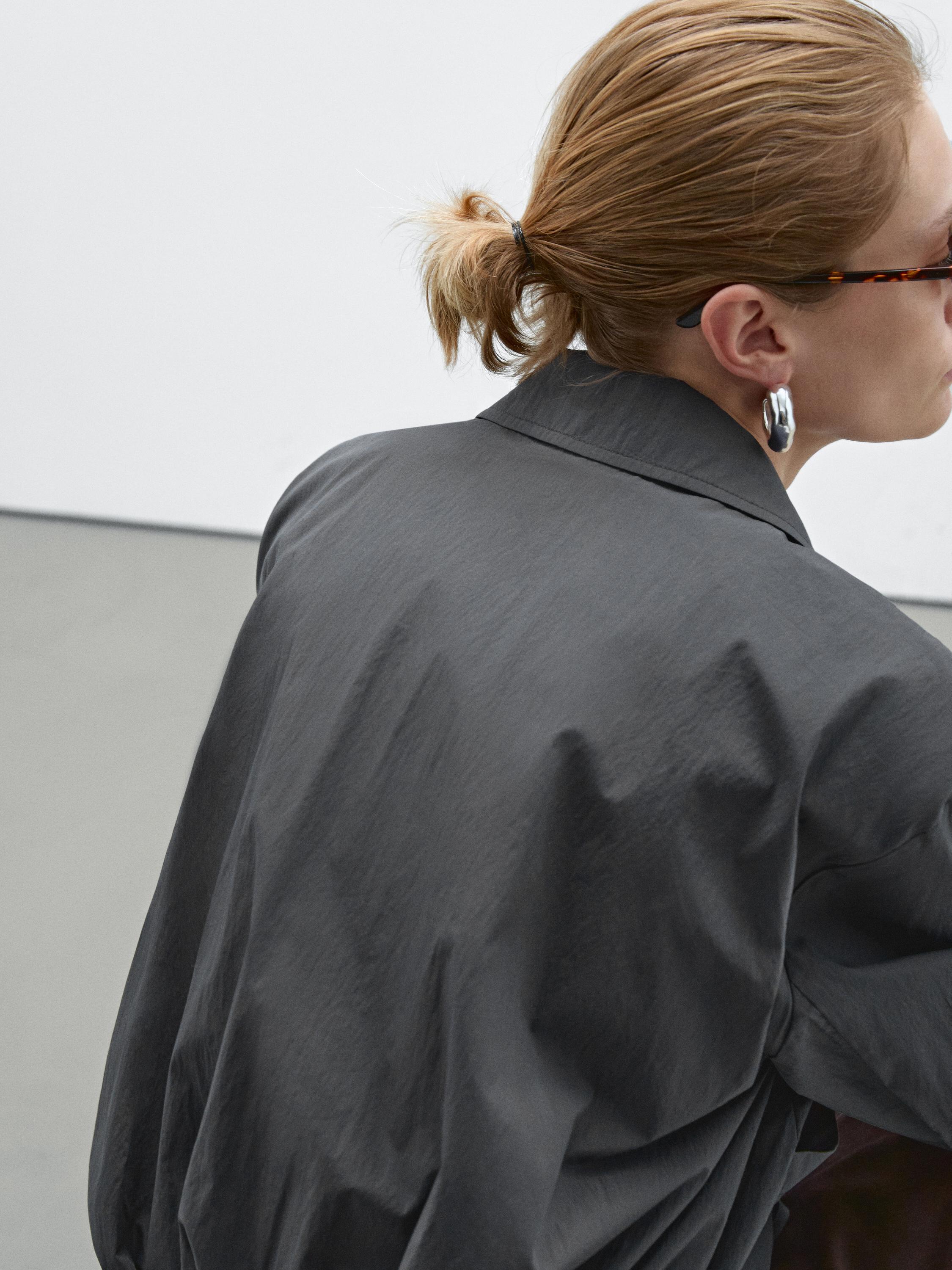 Bomber jacket with seams and gathering