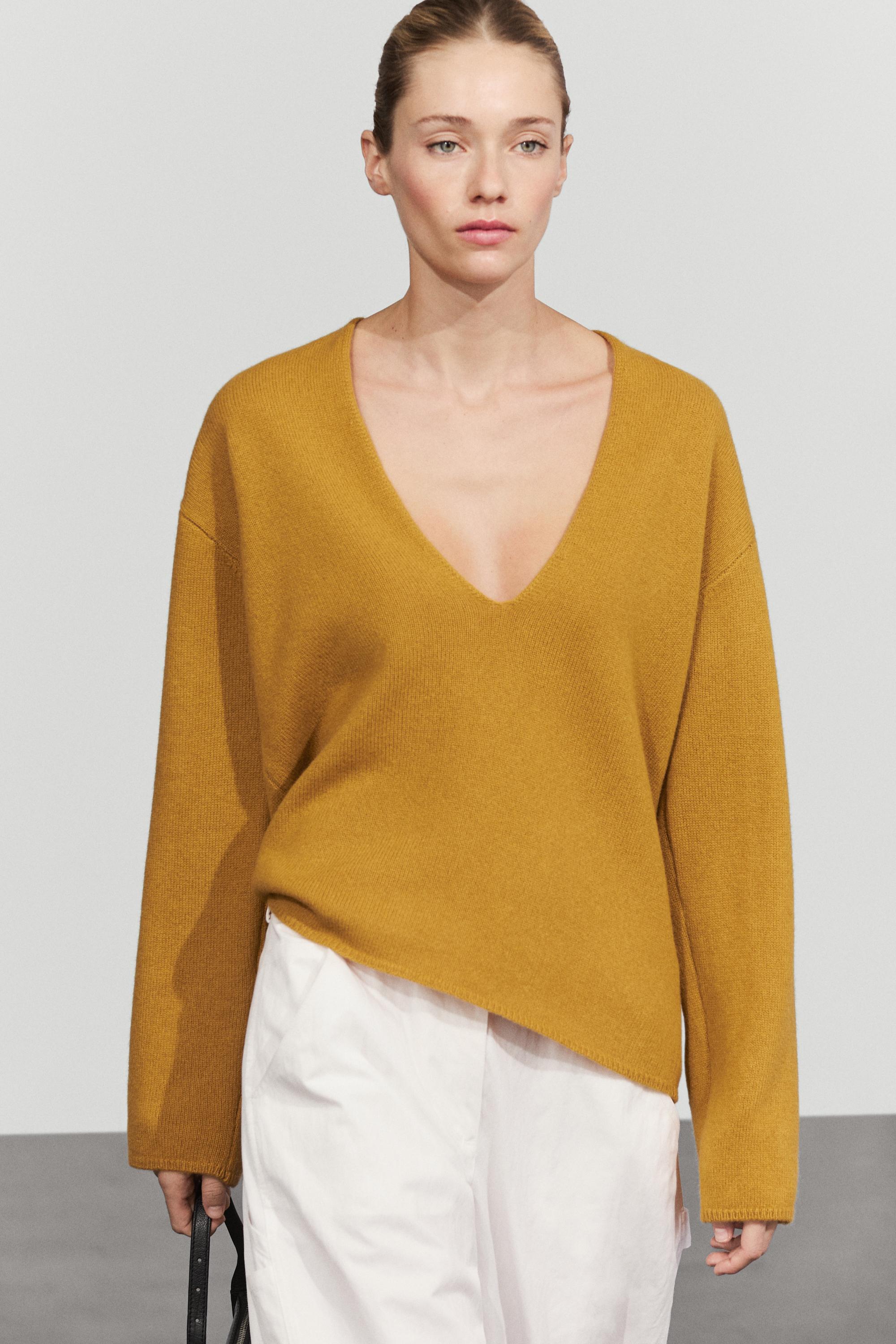 Long-line knit sweater with neckline detail