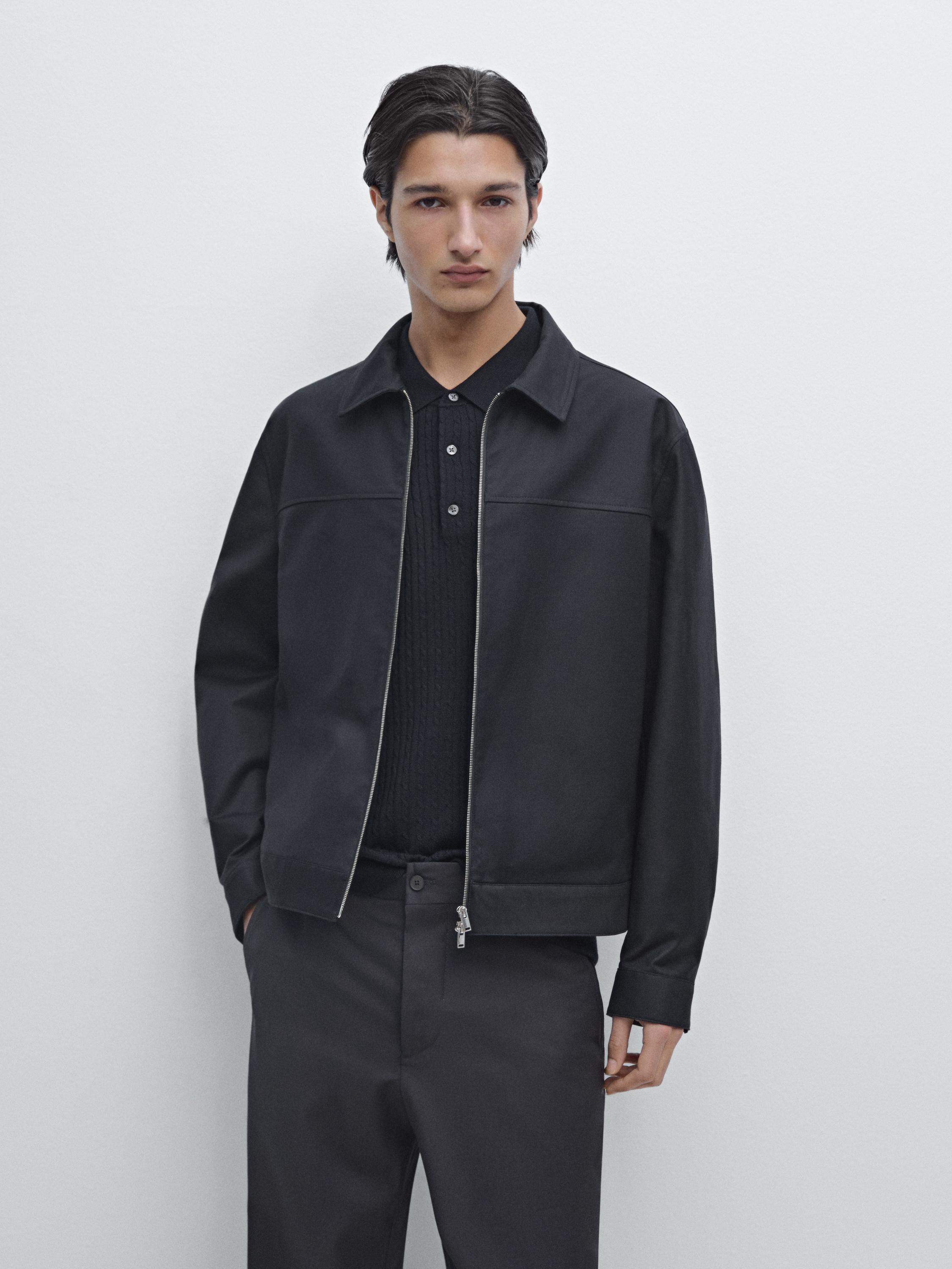 Navy blue zip-up jacket and dark pants set.