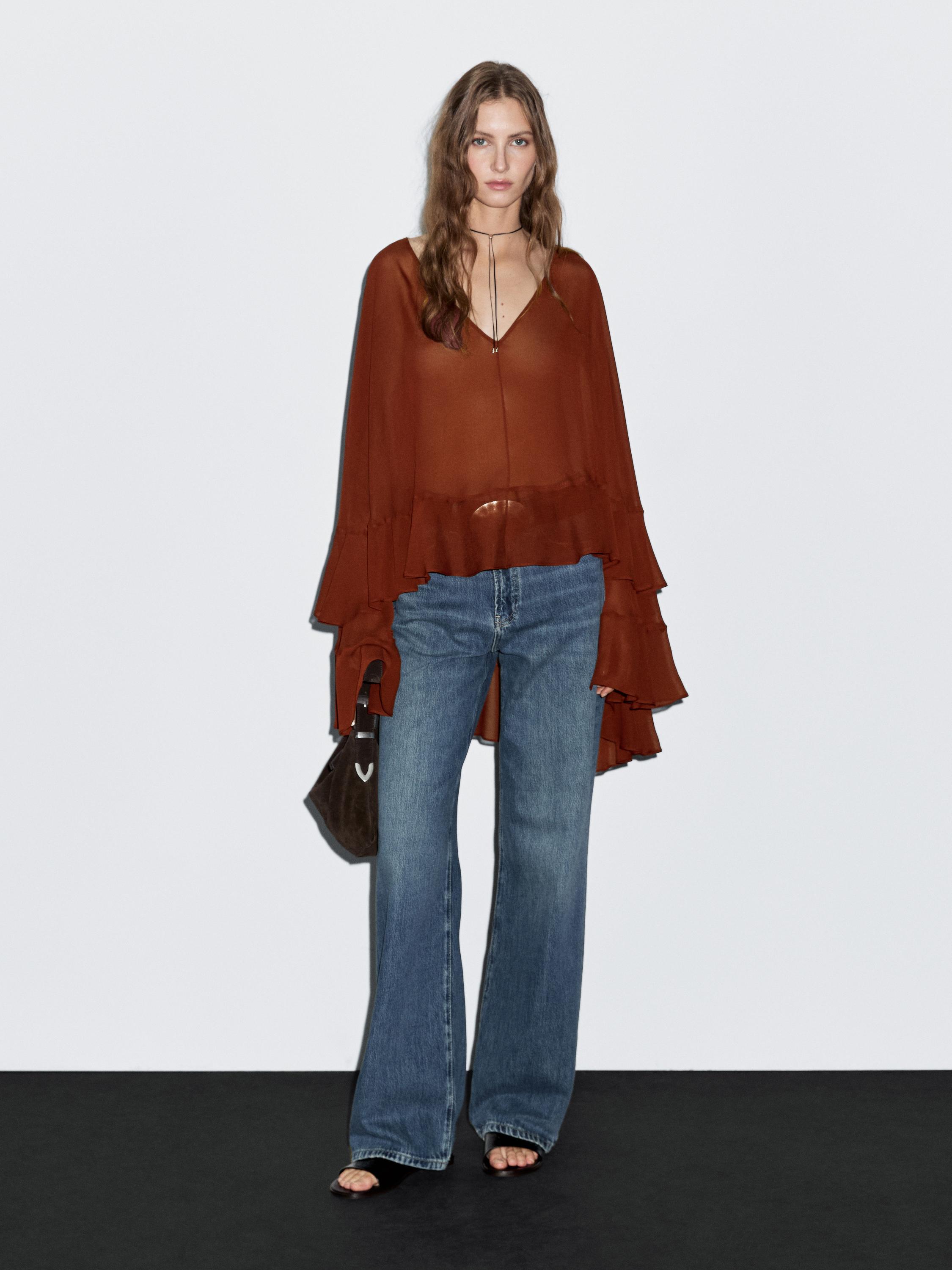 Cape-style blouse with ruffles