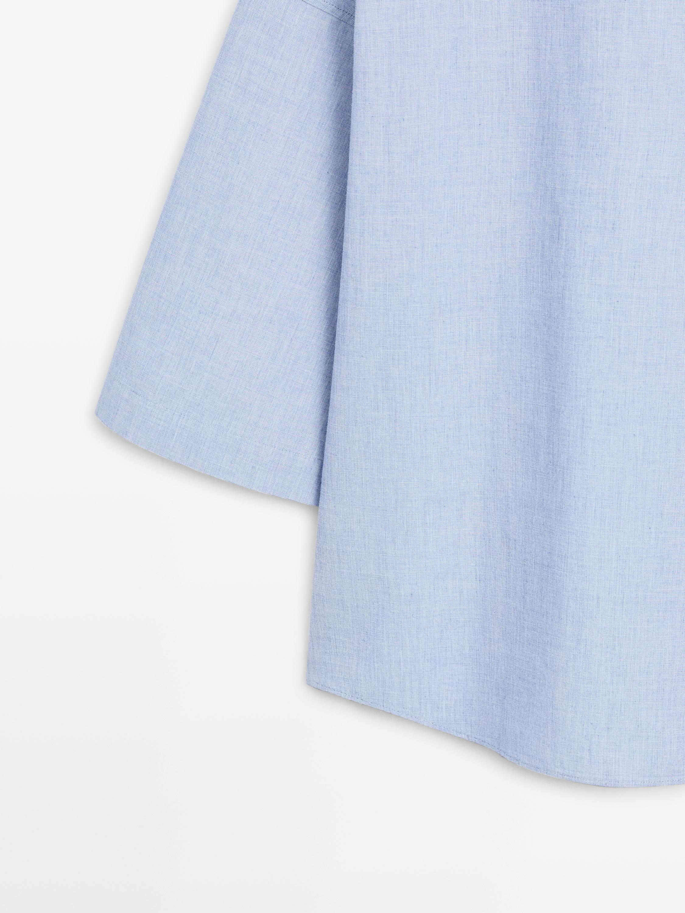 Flowing blouse with buttoned collar detail — Denim blue